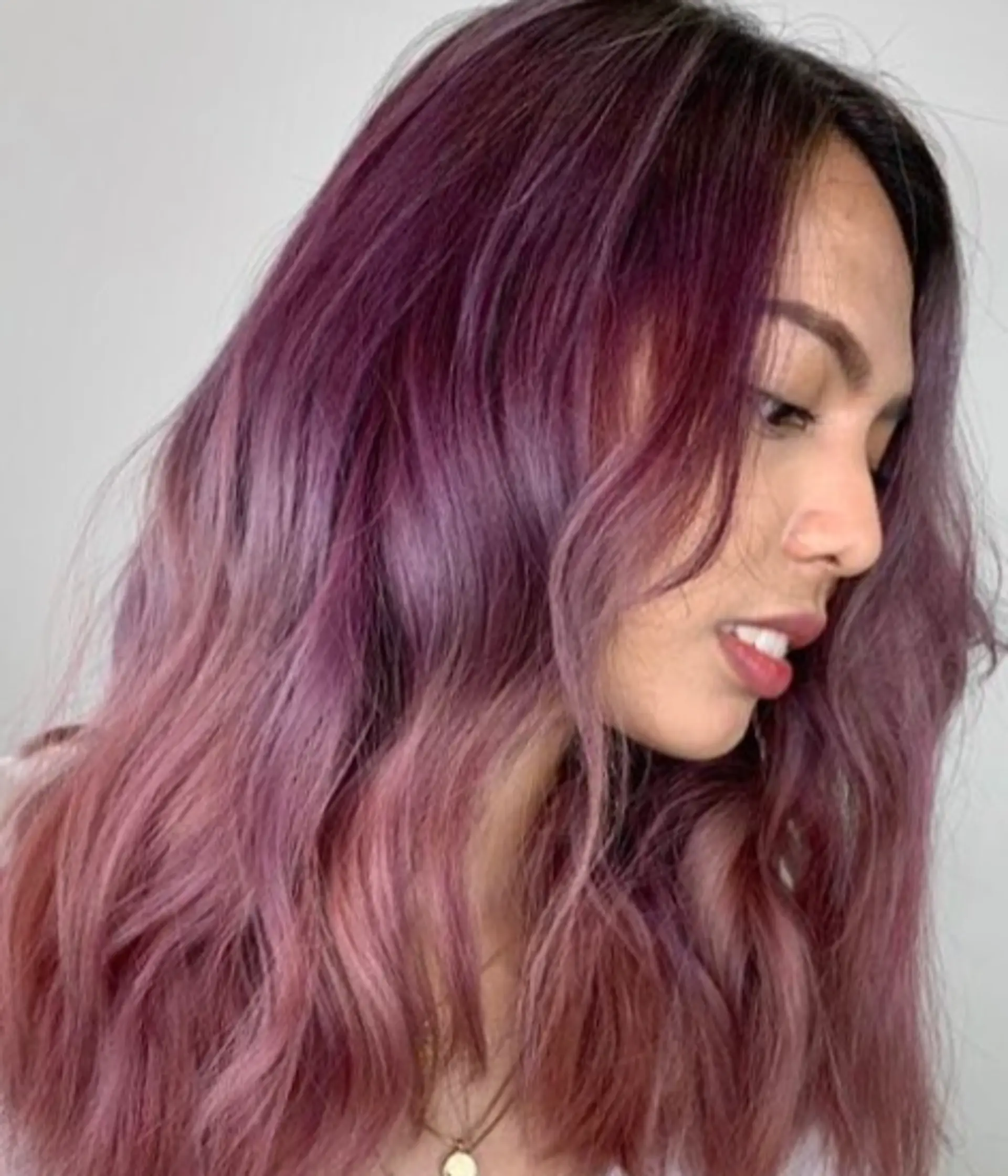 Medium-length hair with a soft, wavy texture, colored in vibrant shades of purple and lavender, featuring a side part. 1