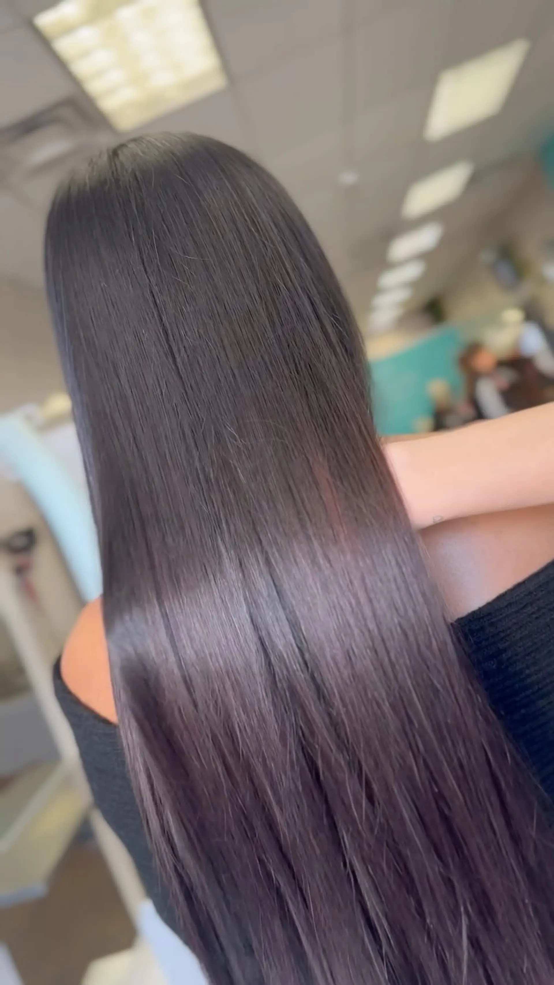 Ultra-sleek, long dark hair straightened to a glossy, smooth, and frizz-free finish. 1