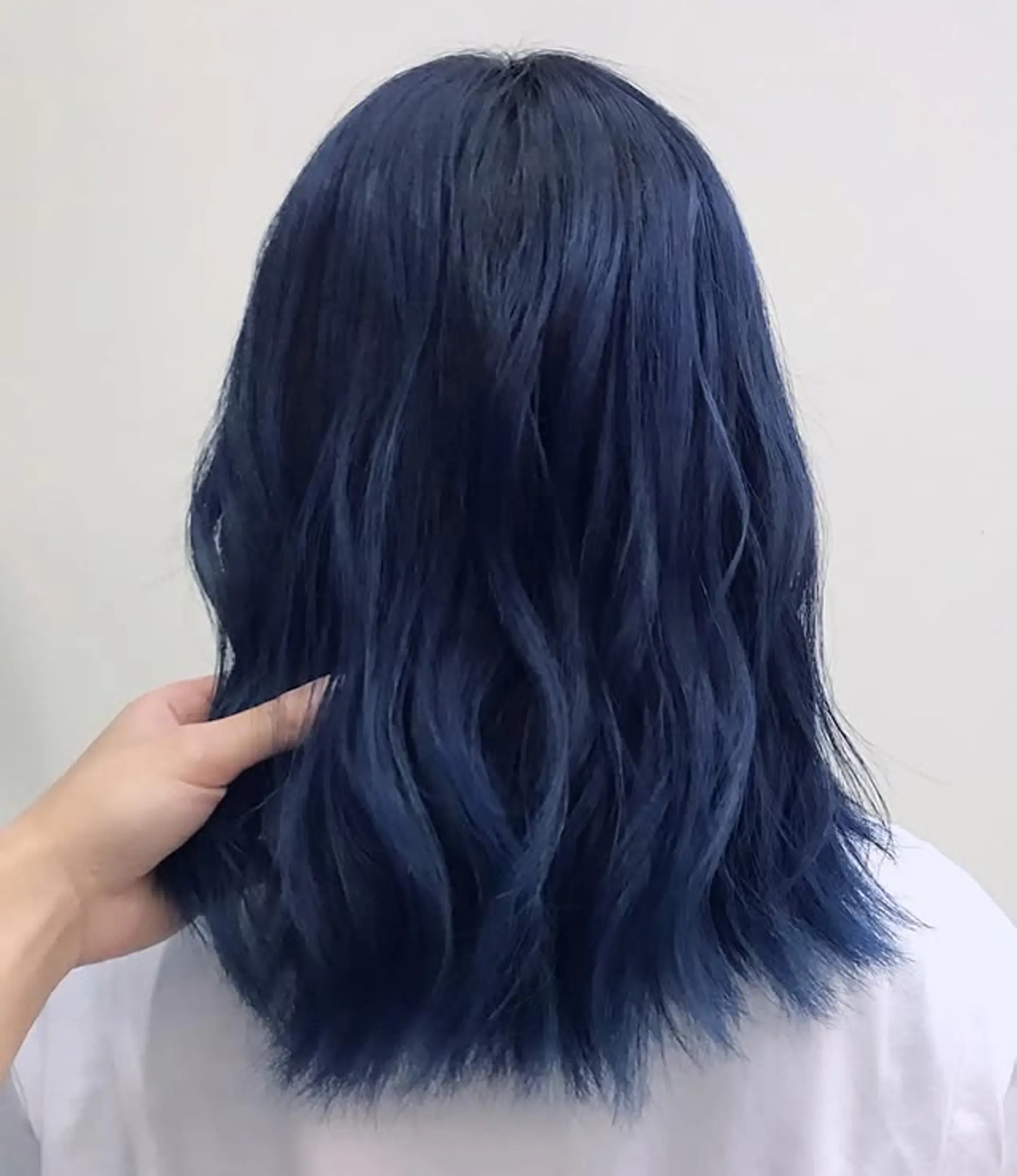 A shoulder-length wavy hairstyle with a modern blue denim color. 1