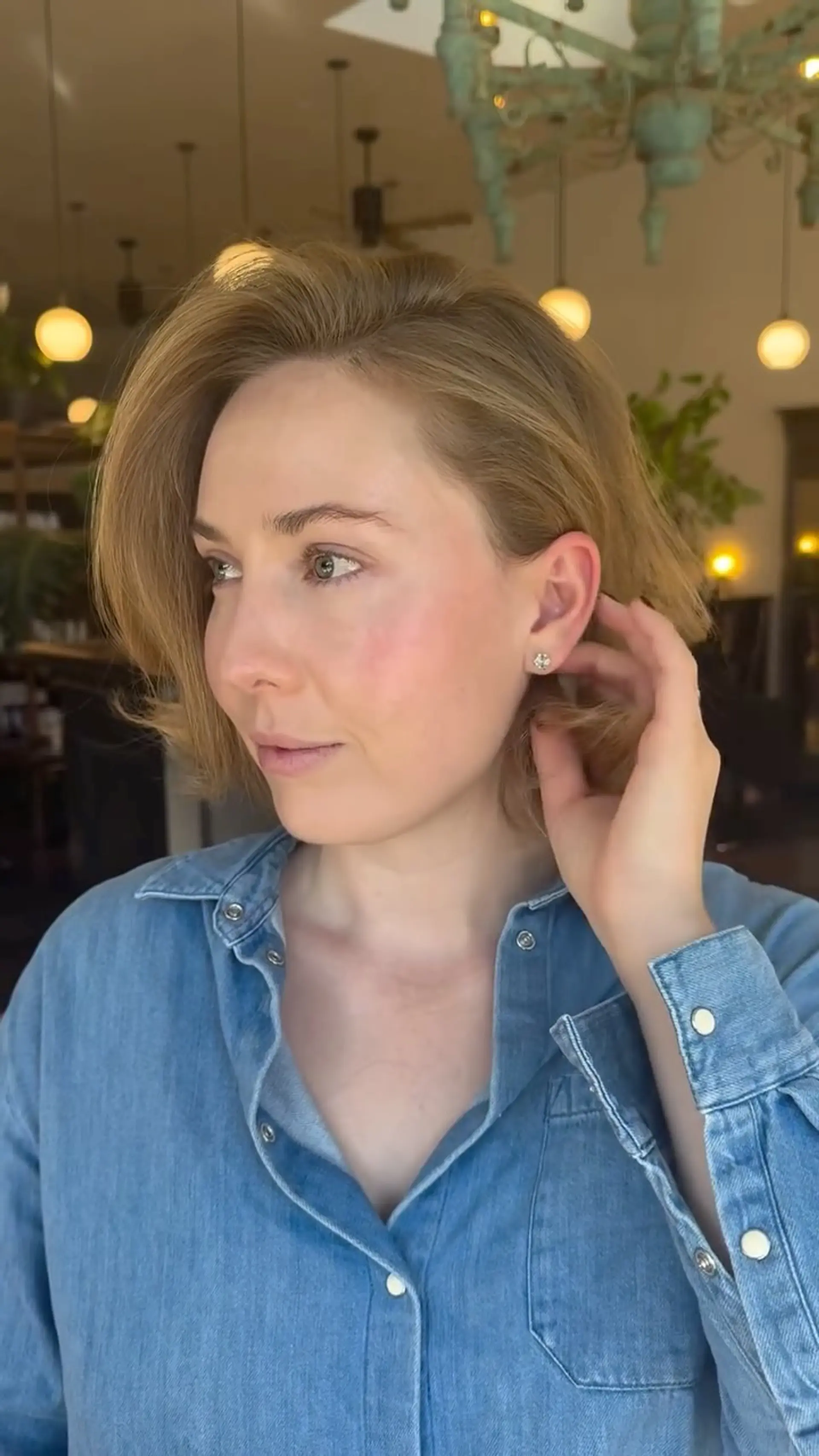 A textured chin-length bob styled with a sweeping side part and soft, voluminous body. 1