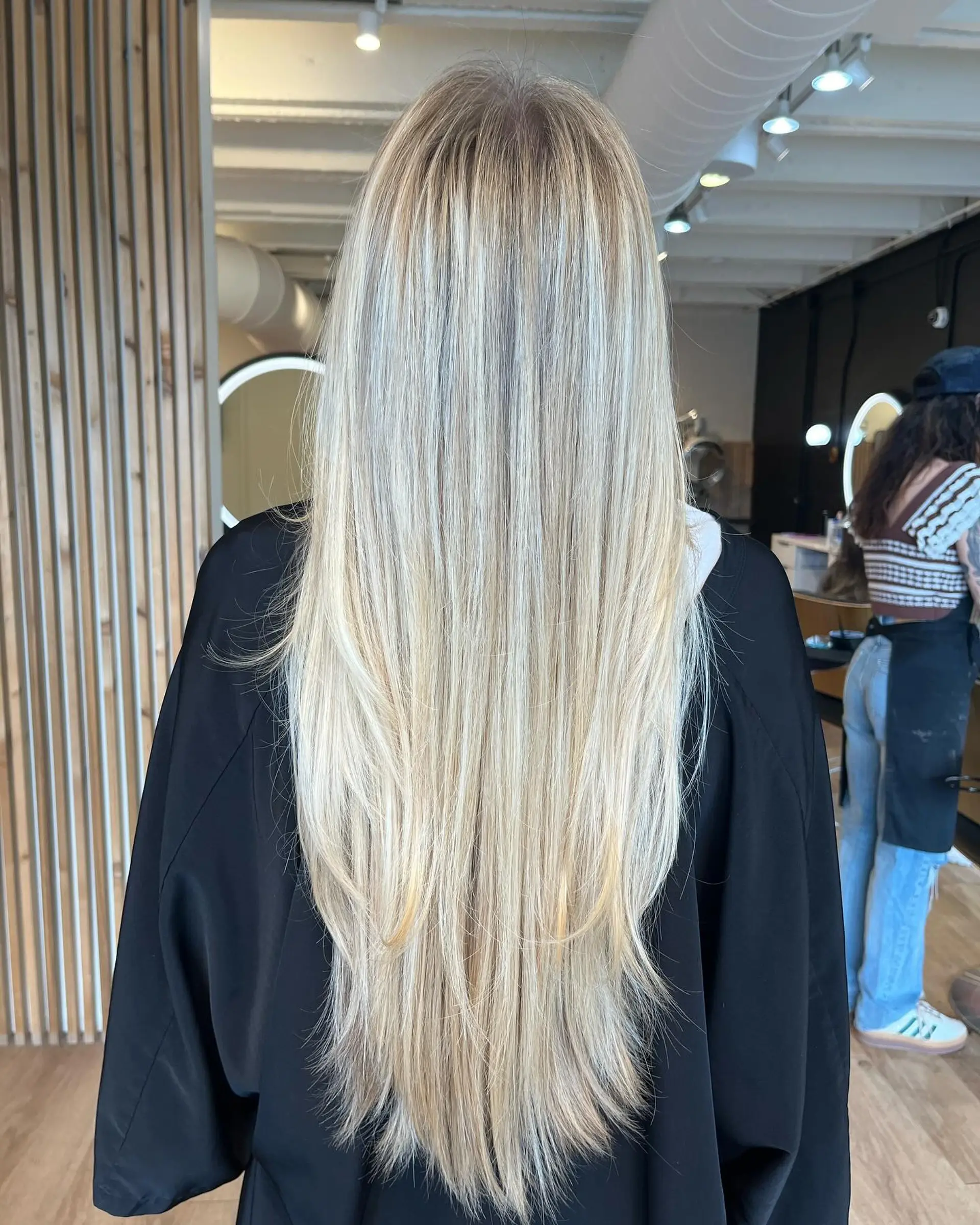 Extra-long straight hair featuring finely blended multi-dimensional blonde highlights and tapered, cascading layers. 1