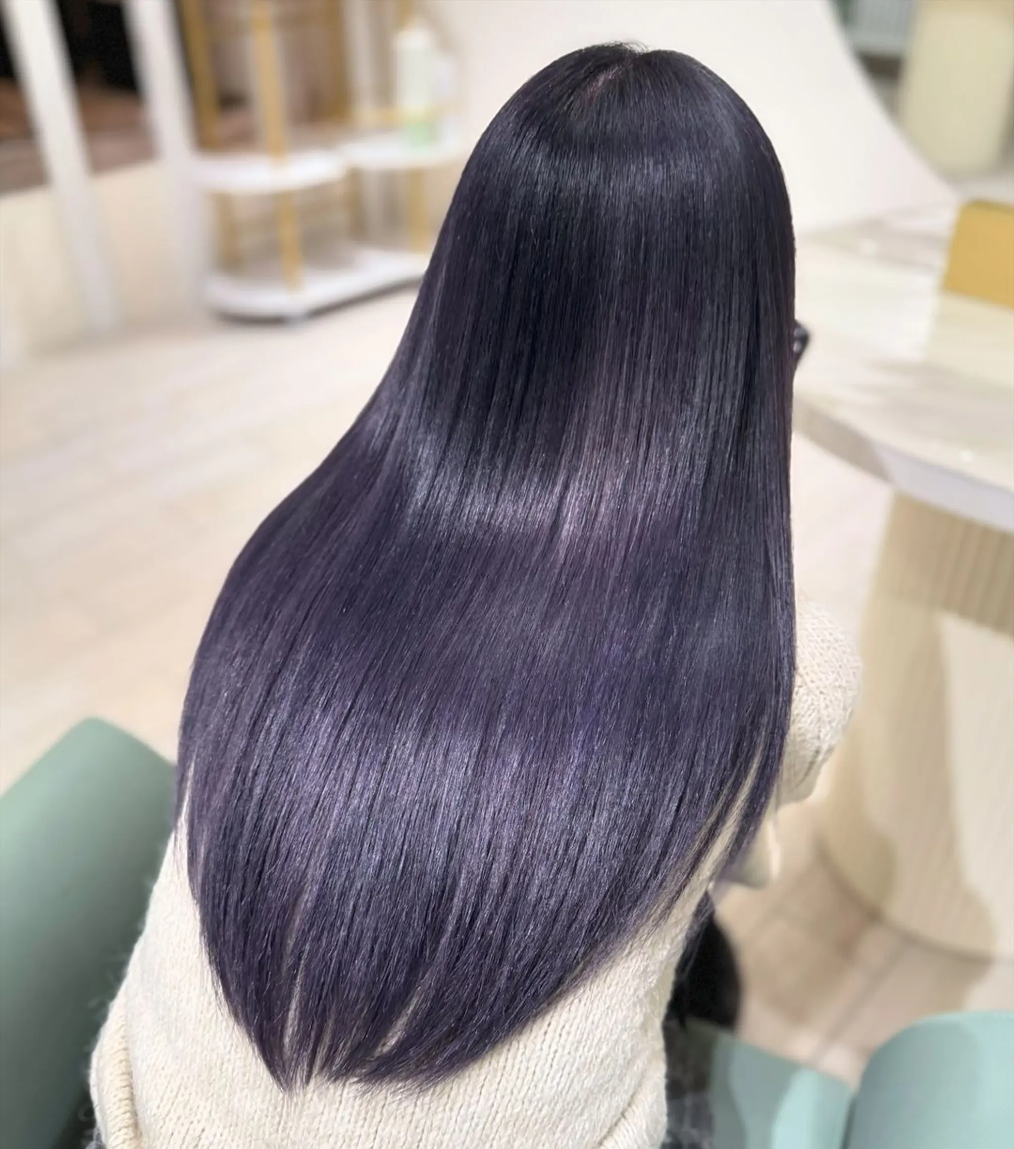 Long, straight, sleek, and glossy black hair that flows smoothly down the back.
