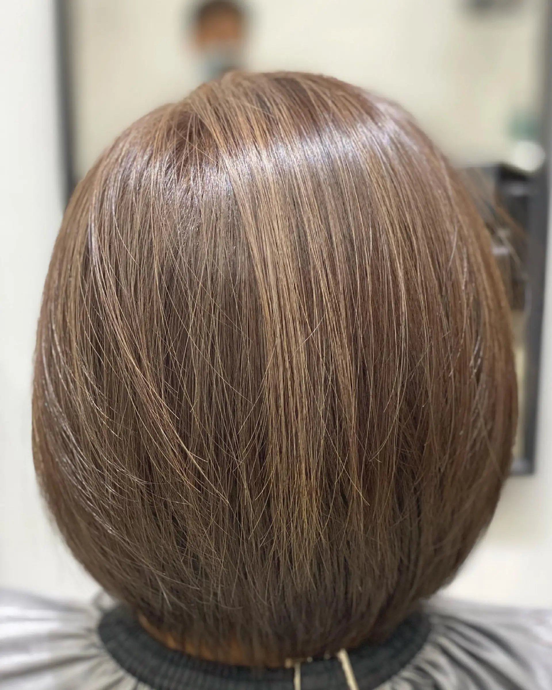 A sleek and polished brunette bob with subtle caramel highlights. 1