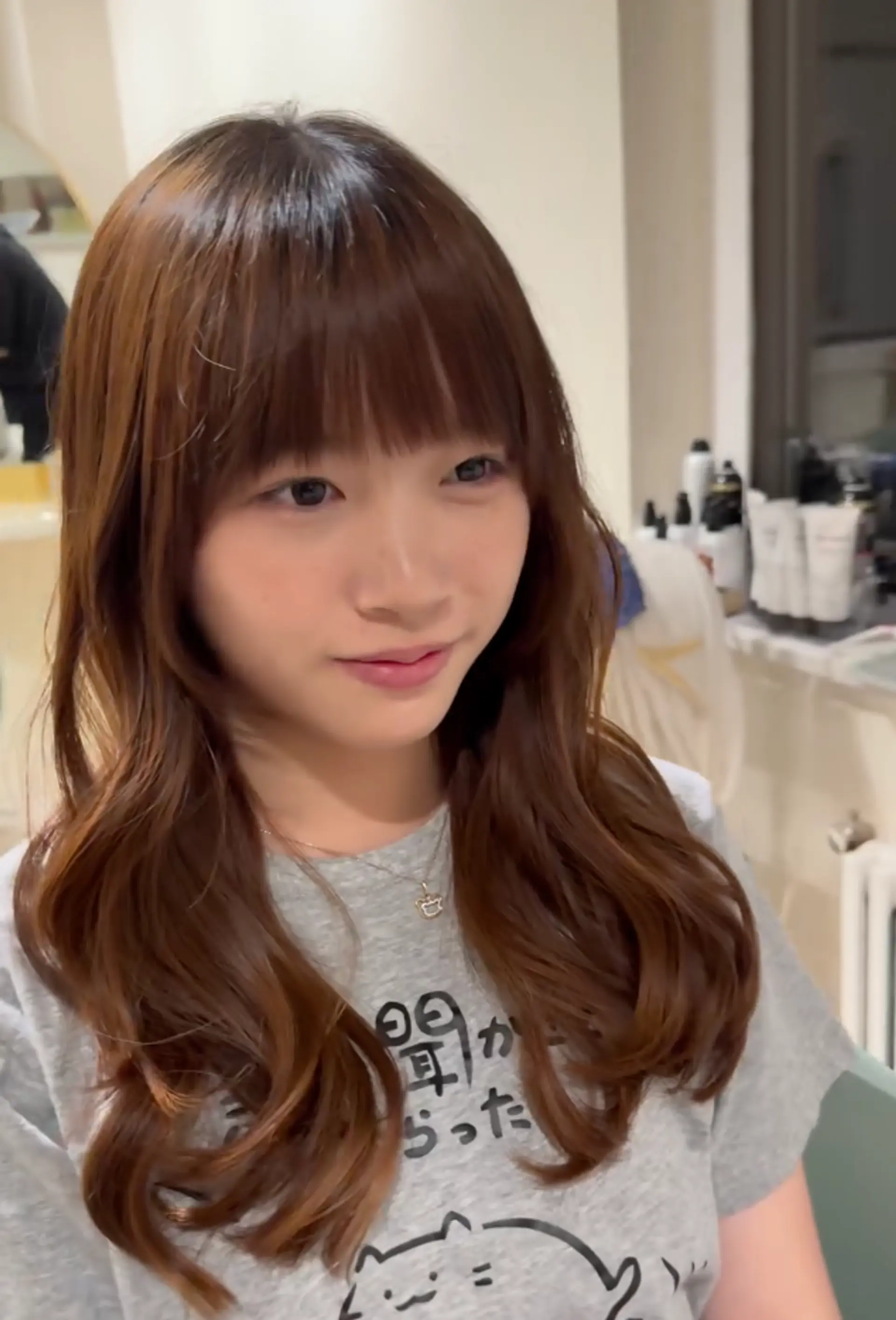 Medium-length wavy chestnut brown hair with curtain bangs, soft waves, and a natural sheen.

Stylist: @yurihair.newyork 1