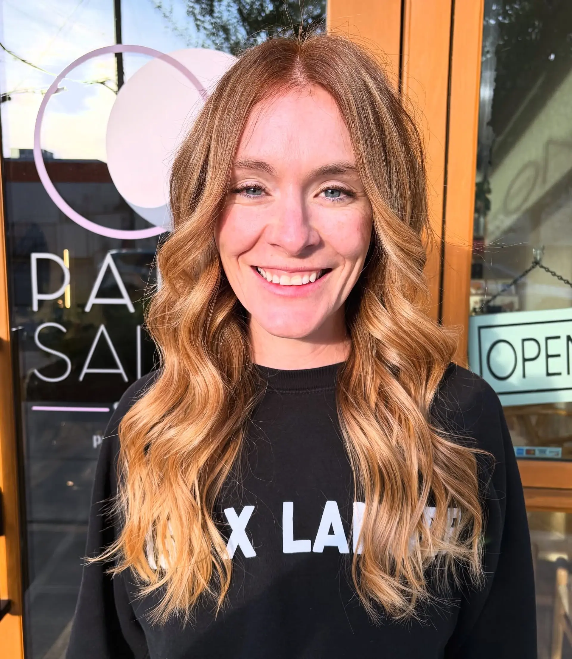 Long strawberry blonde hair styled in soft, loose waves with a center part. 1