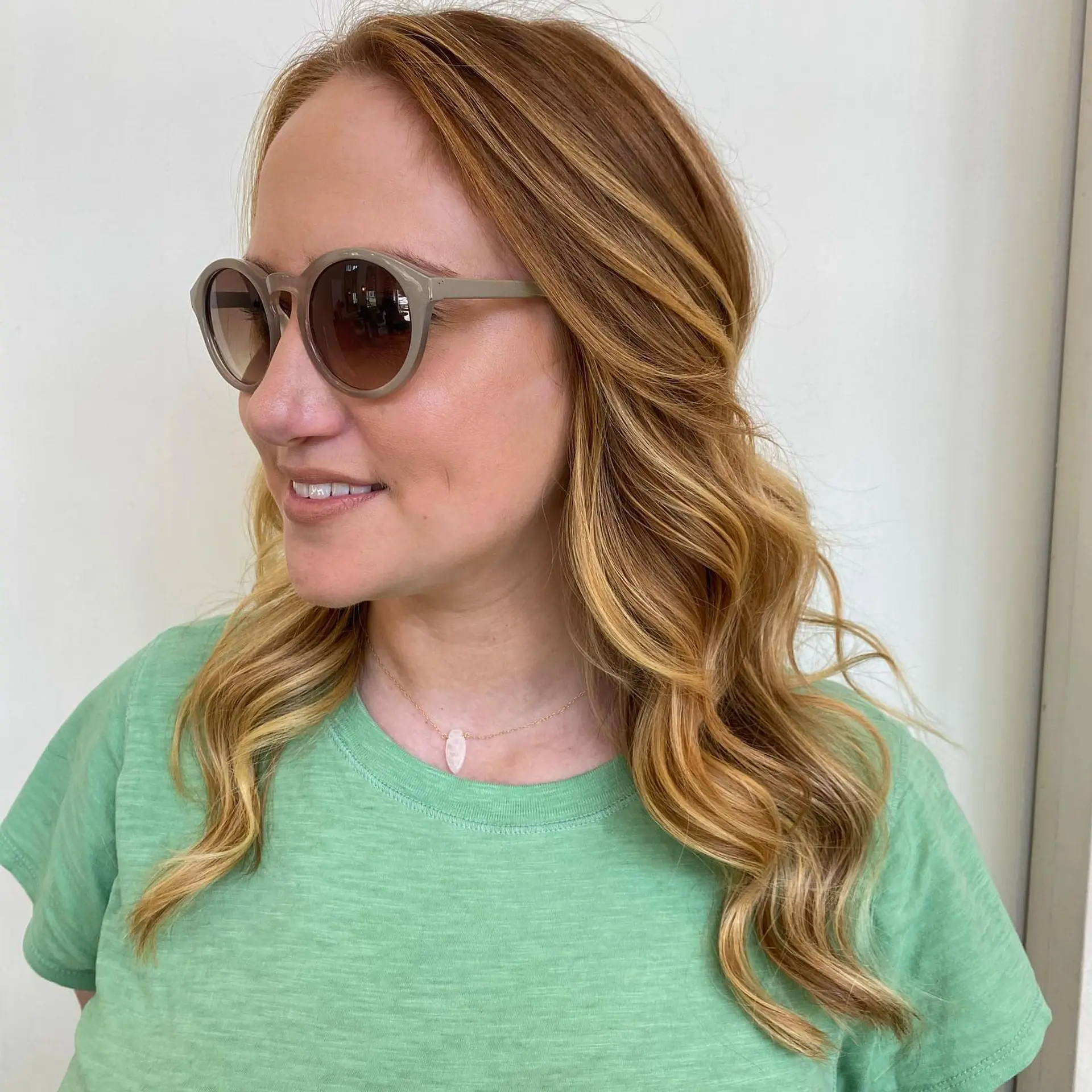 Medium-length strawberry blonde hair with multi-dimensional warm highlights, styled into soft, loose waves. 1