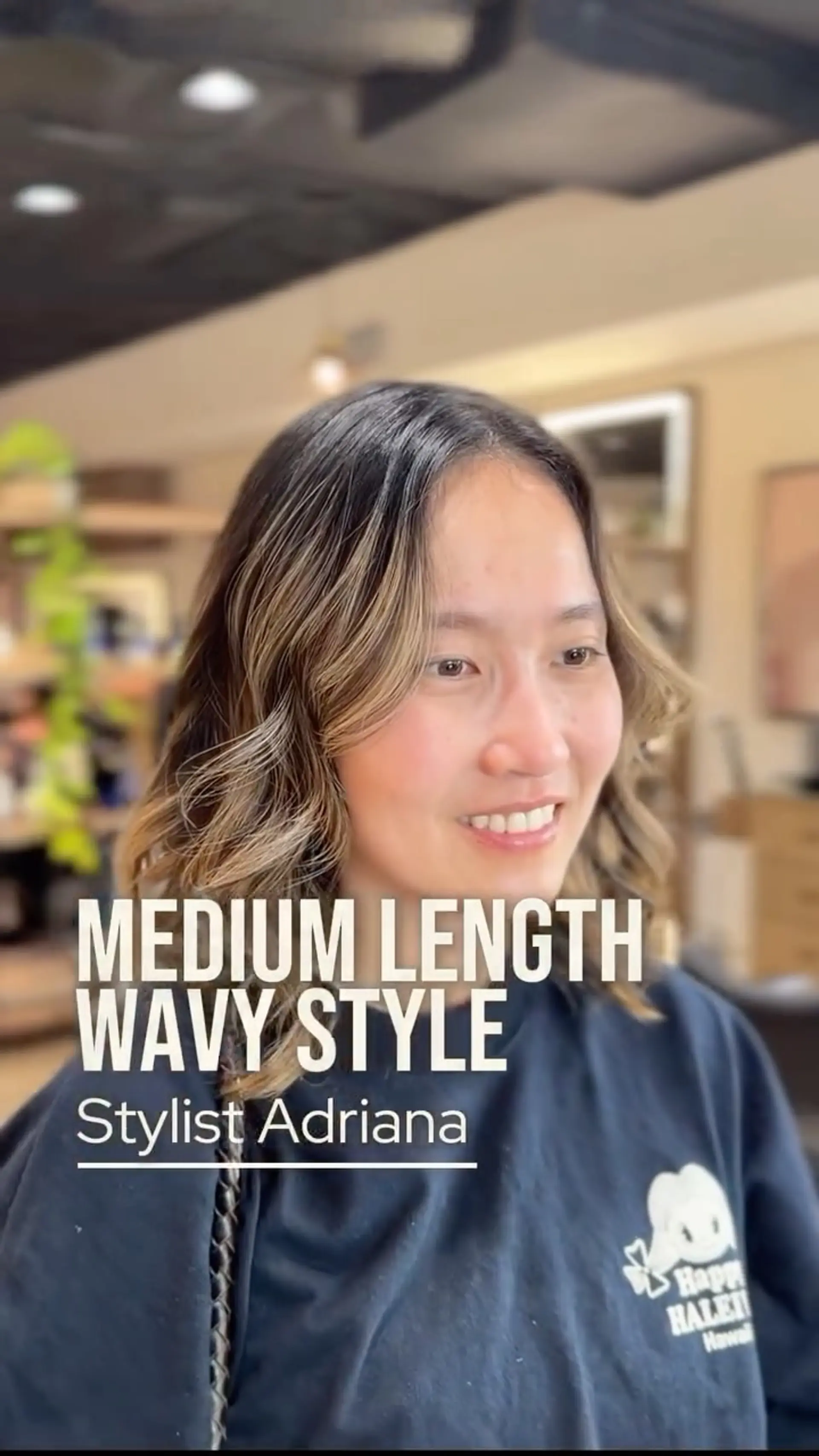 Medium-length layered haircut styled into loose, effortless waves with face-framing dimensional highlights. 1