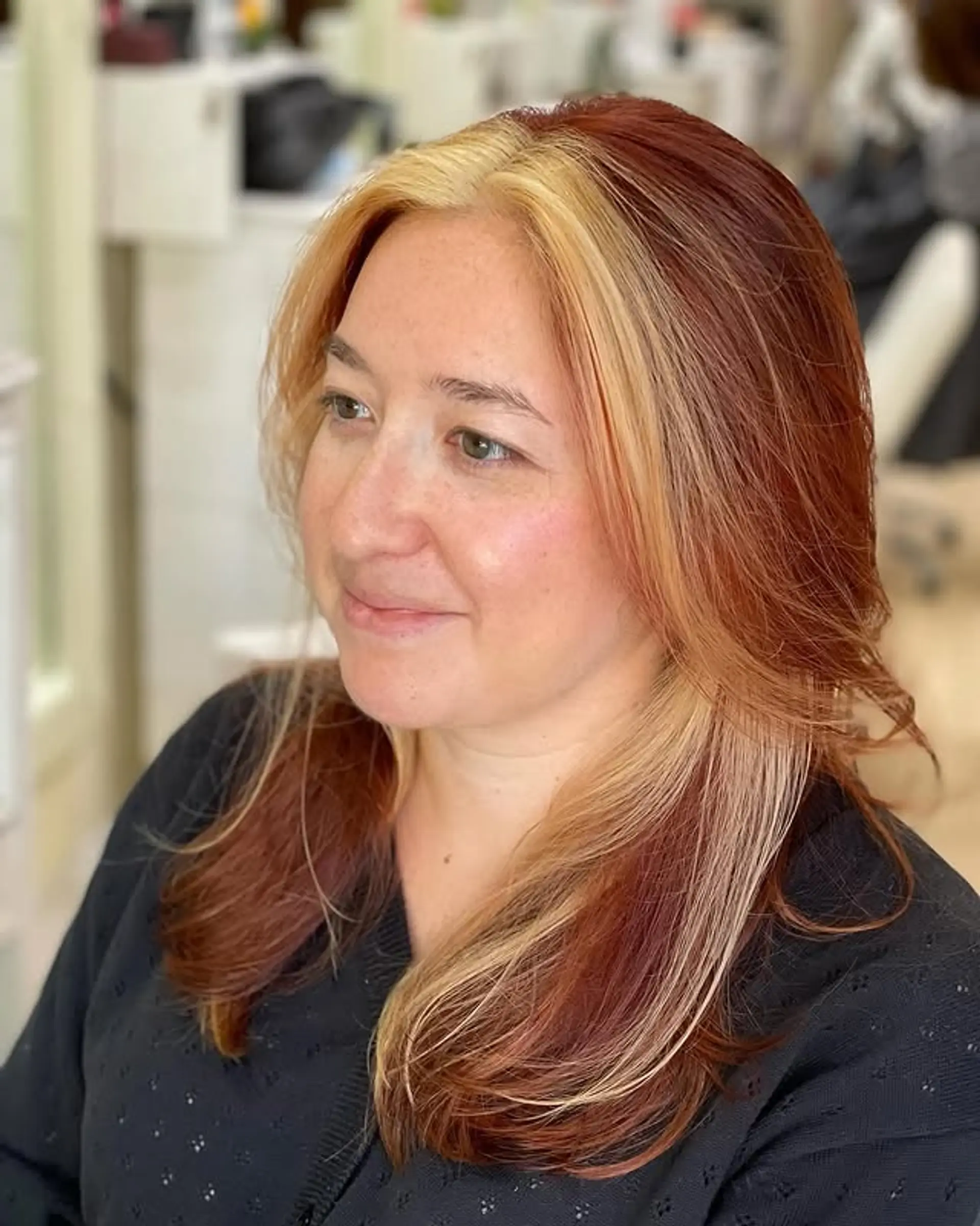 Copper highlights with a bold blonde money piece create a face-framing color melt effect. 1