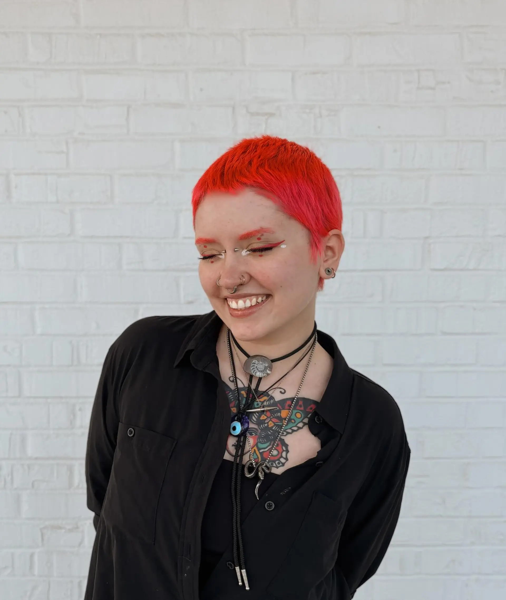 A vibrant neon coral-pink textured crop cut featuring short micro bangs and closely cropped sides. 1