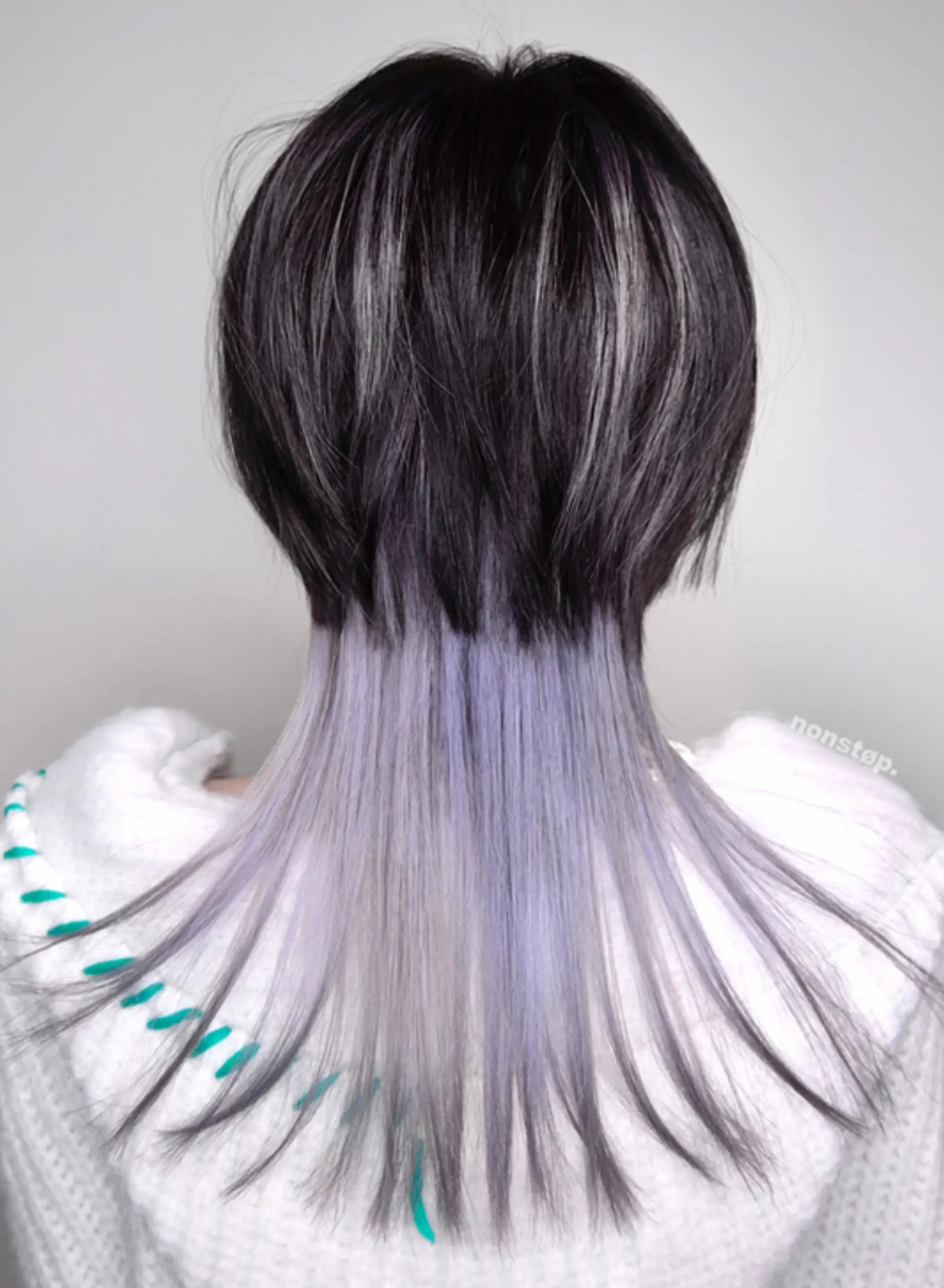 Straight, long layers that transition from black at the roots to gray and finish with pastel lavender tips. The finely cut layers provide a feathered look at the ends for a sleek and chic appearance.

(NonstopStyle: by Ben)
