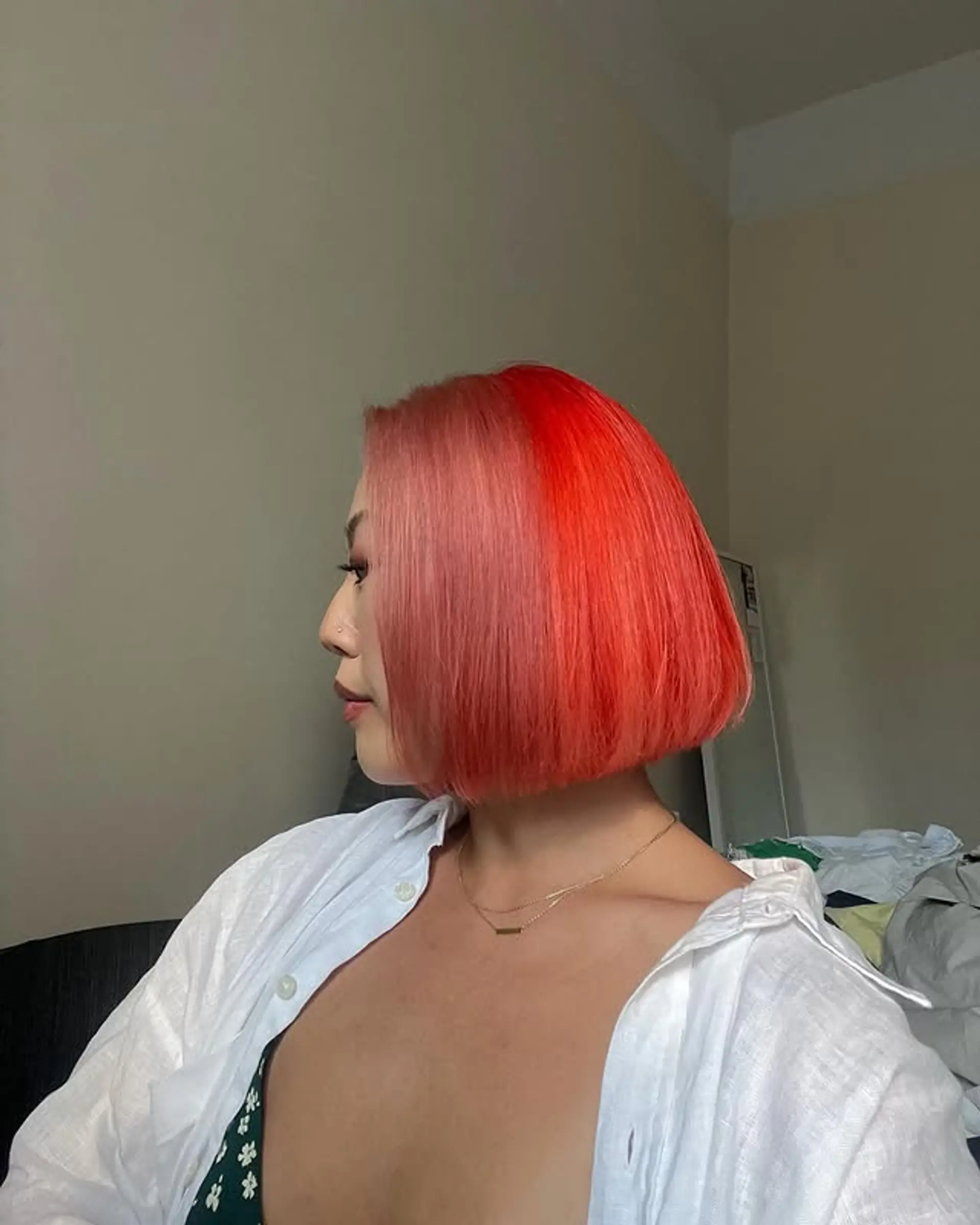 A short, blunt bob with a striking two-tone color design, featuring a bold contrast between red and pink. 1