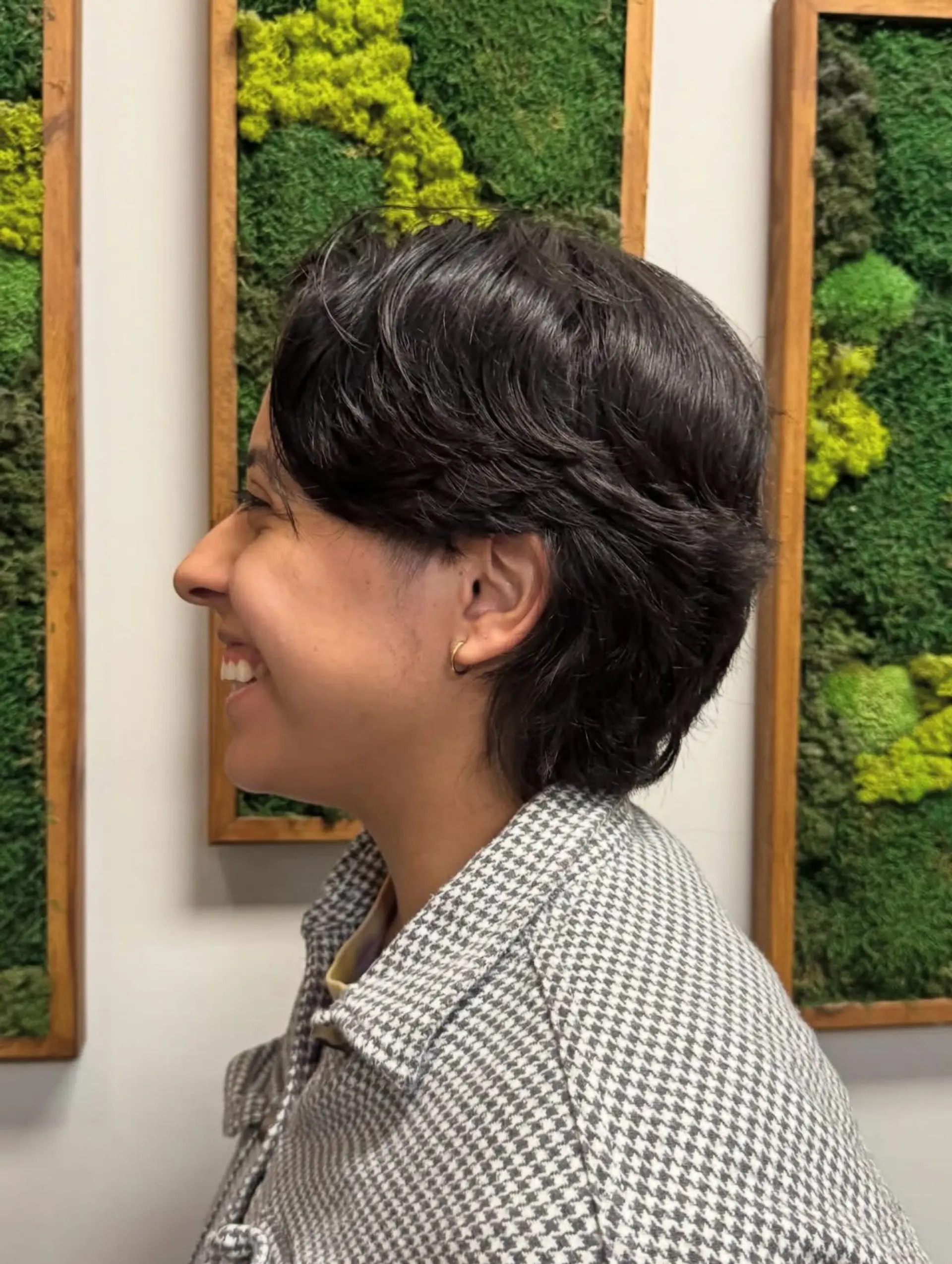 A side-profile view of a textured short haircut featuring soft layers and natural movement. 1