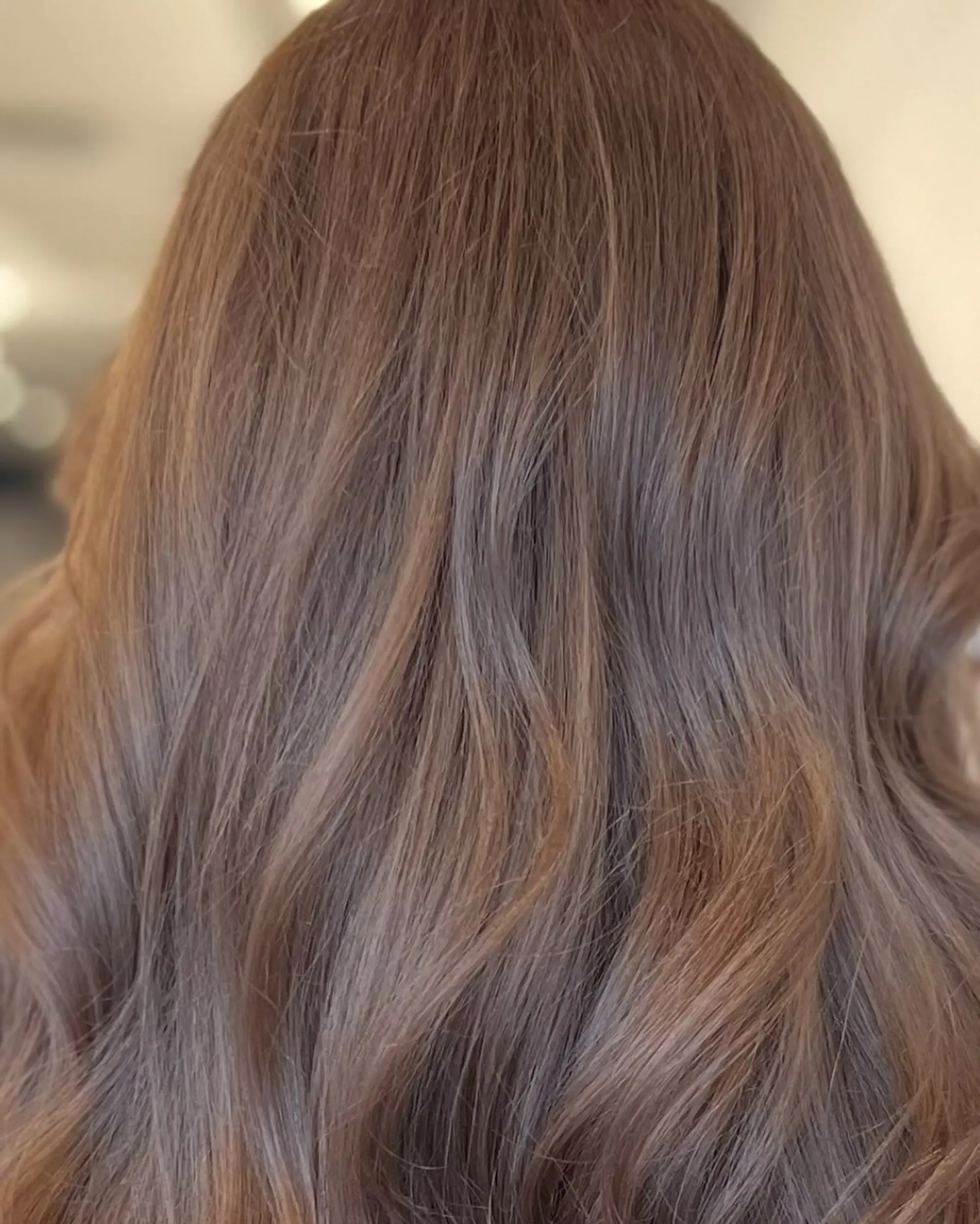 Medium-length light ash brown hair styled into soft, loose dimensional waves. 1