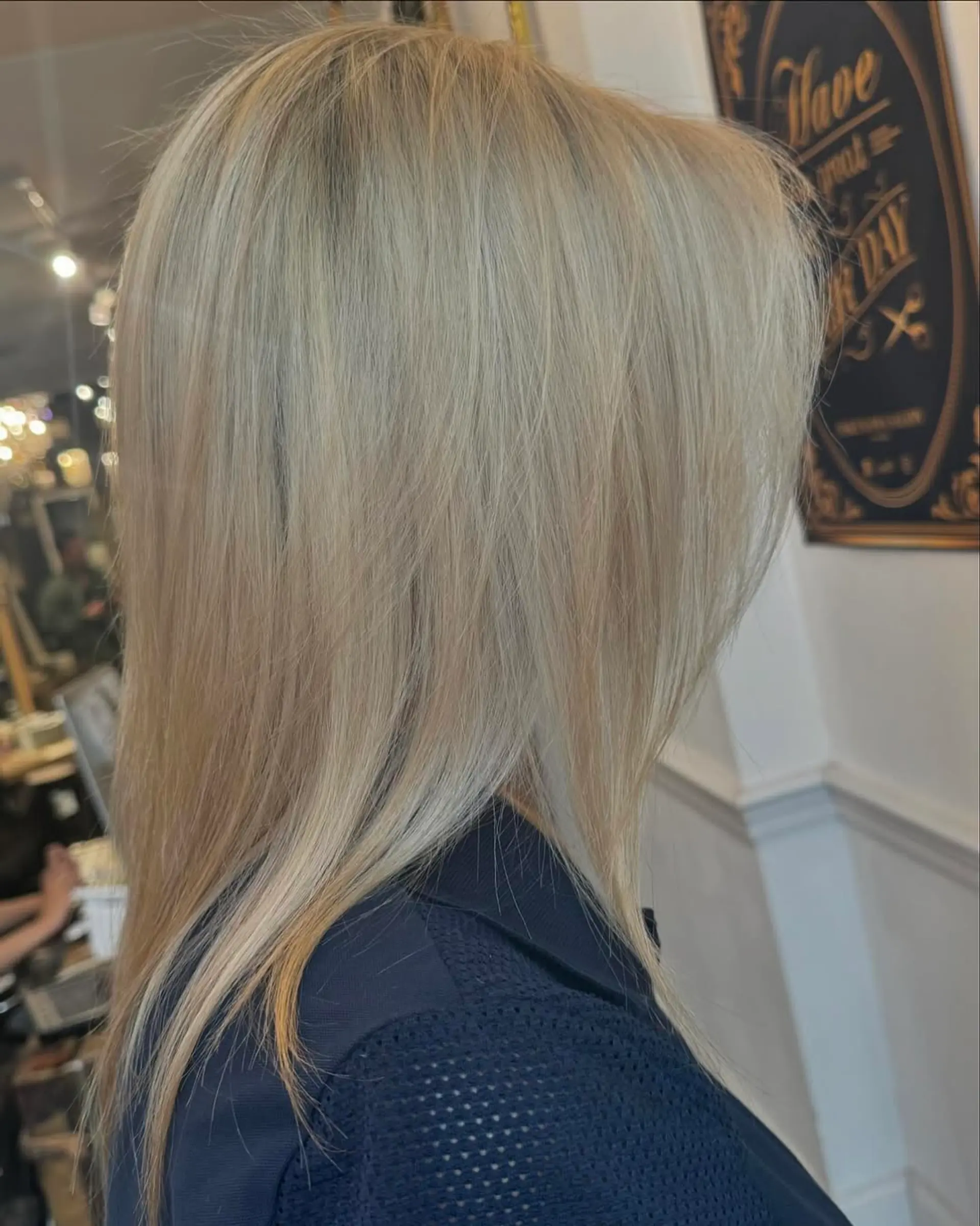 Long, straight, layered blonde hair with a platinum sheen, featuring a smooth and sleek finish. 2