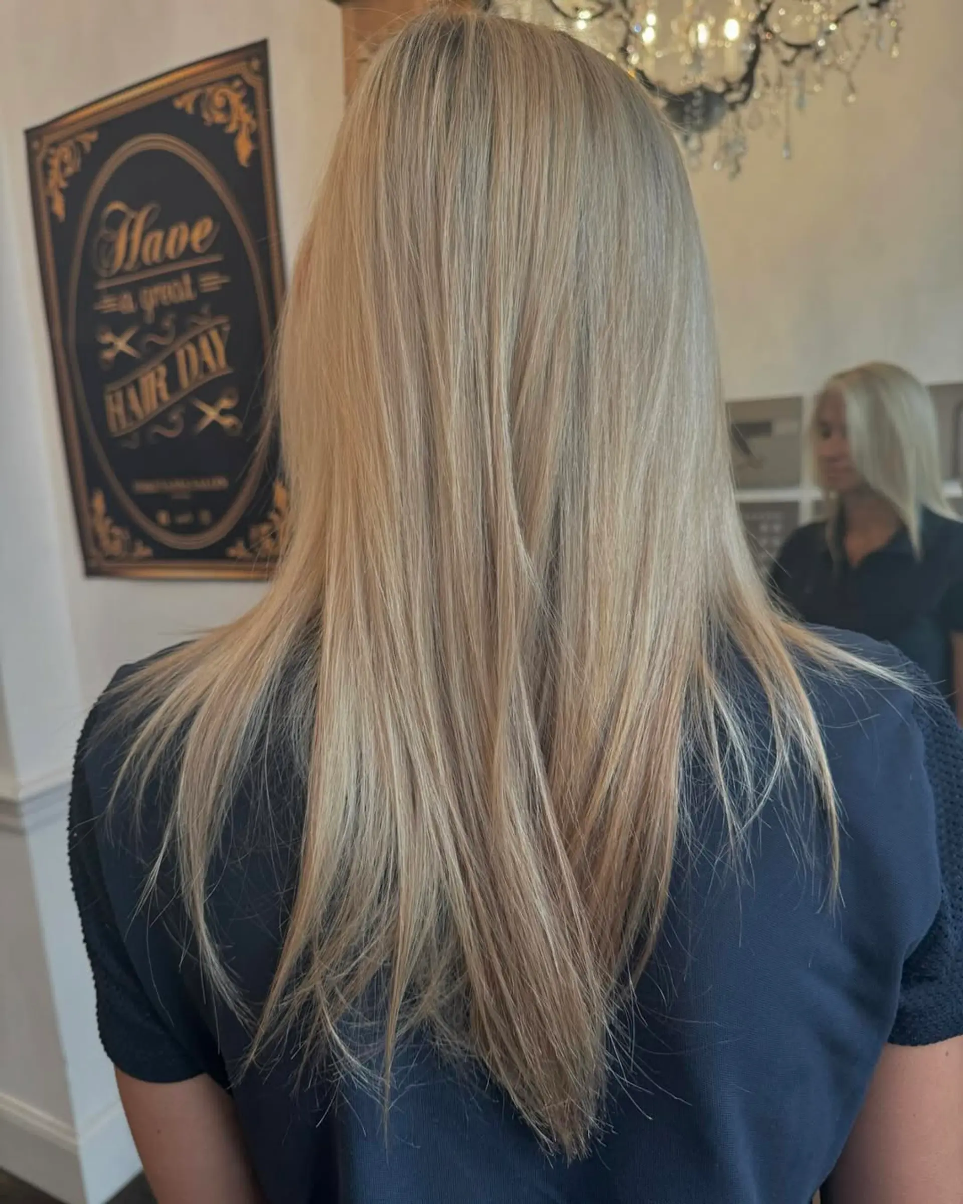 Long, straight, layered blonde hair with a platinum sheen, featuring a smooth and sleek finish. 1