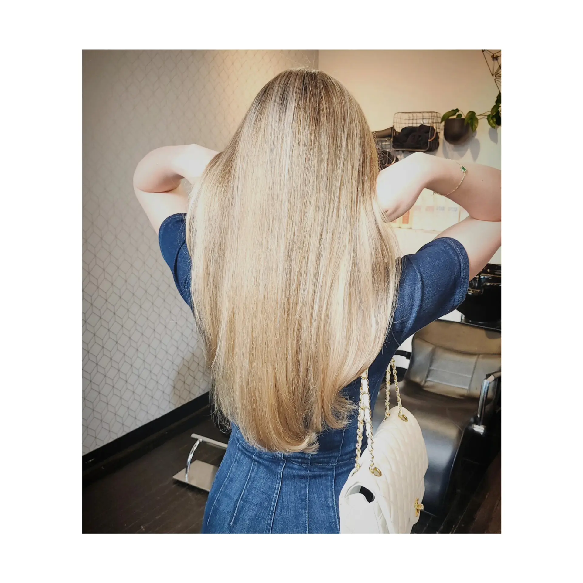 Extra-long dimensional blonde hair styled into a smooth, sleek blowout with subtly curved ends. 1