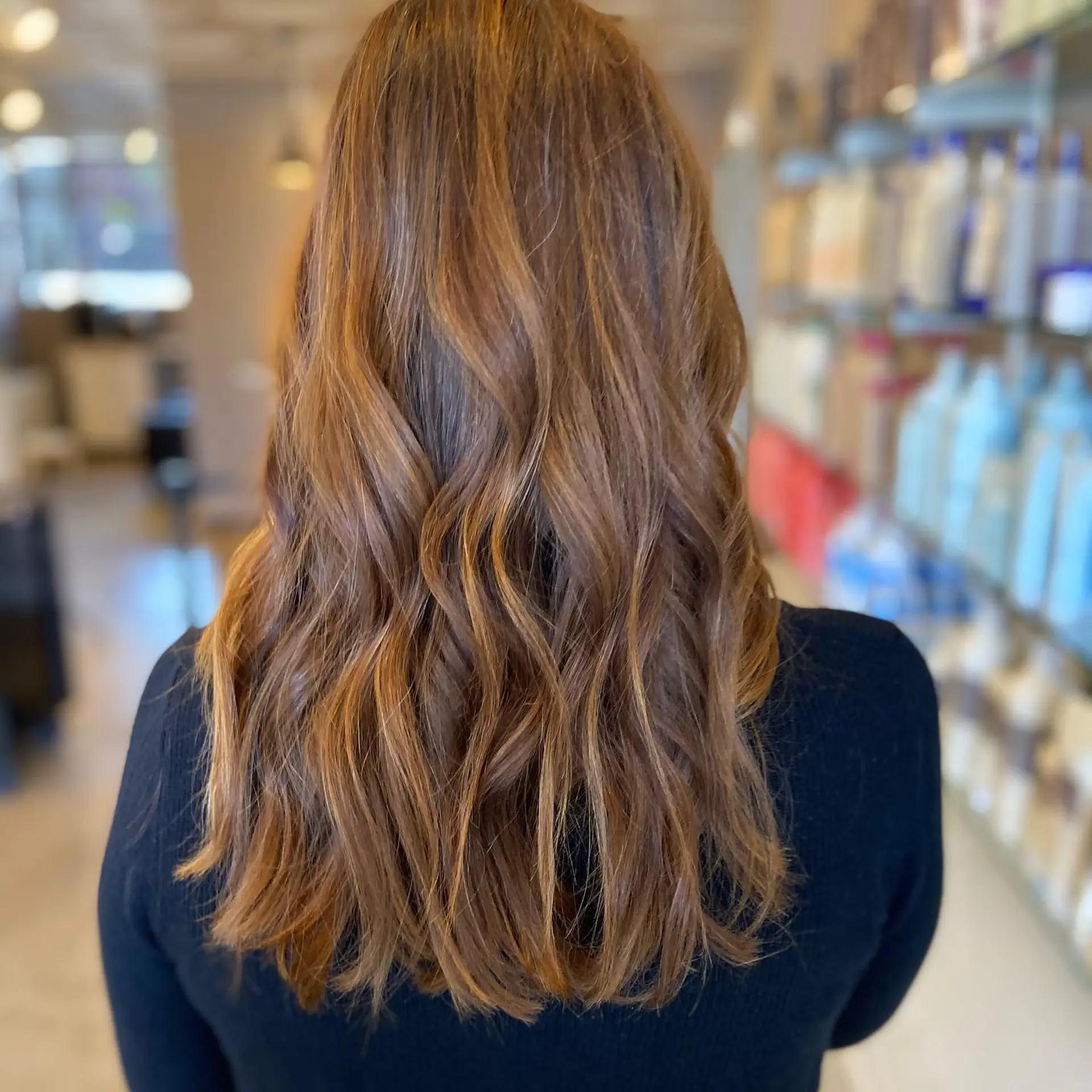 Long natural auburn hair cut with subtle layers and styled into relaxed, flowing waves. 1