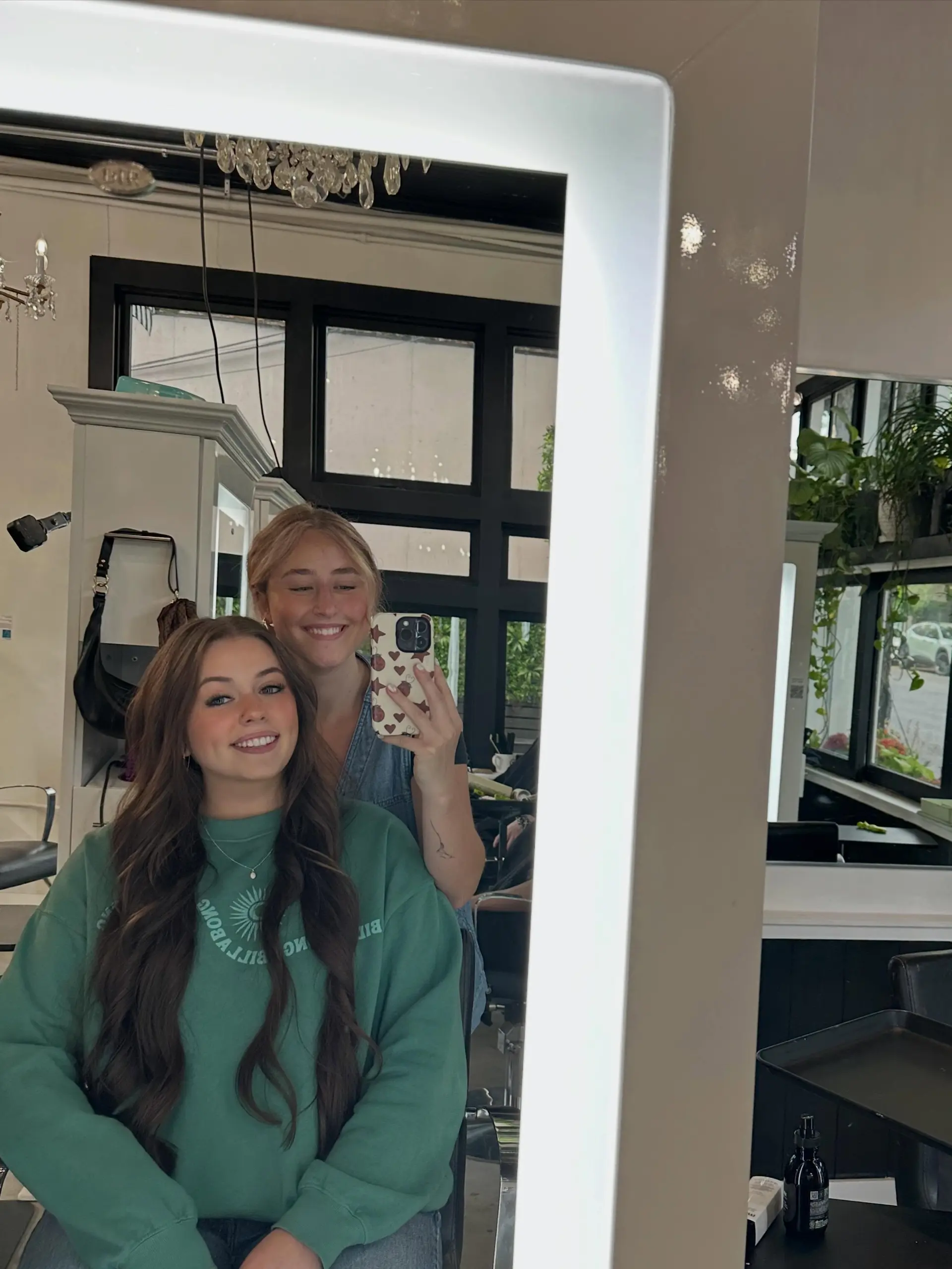 Long brunette hair cut and styled into voluminous, flowing waves with a neat center part. 1