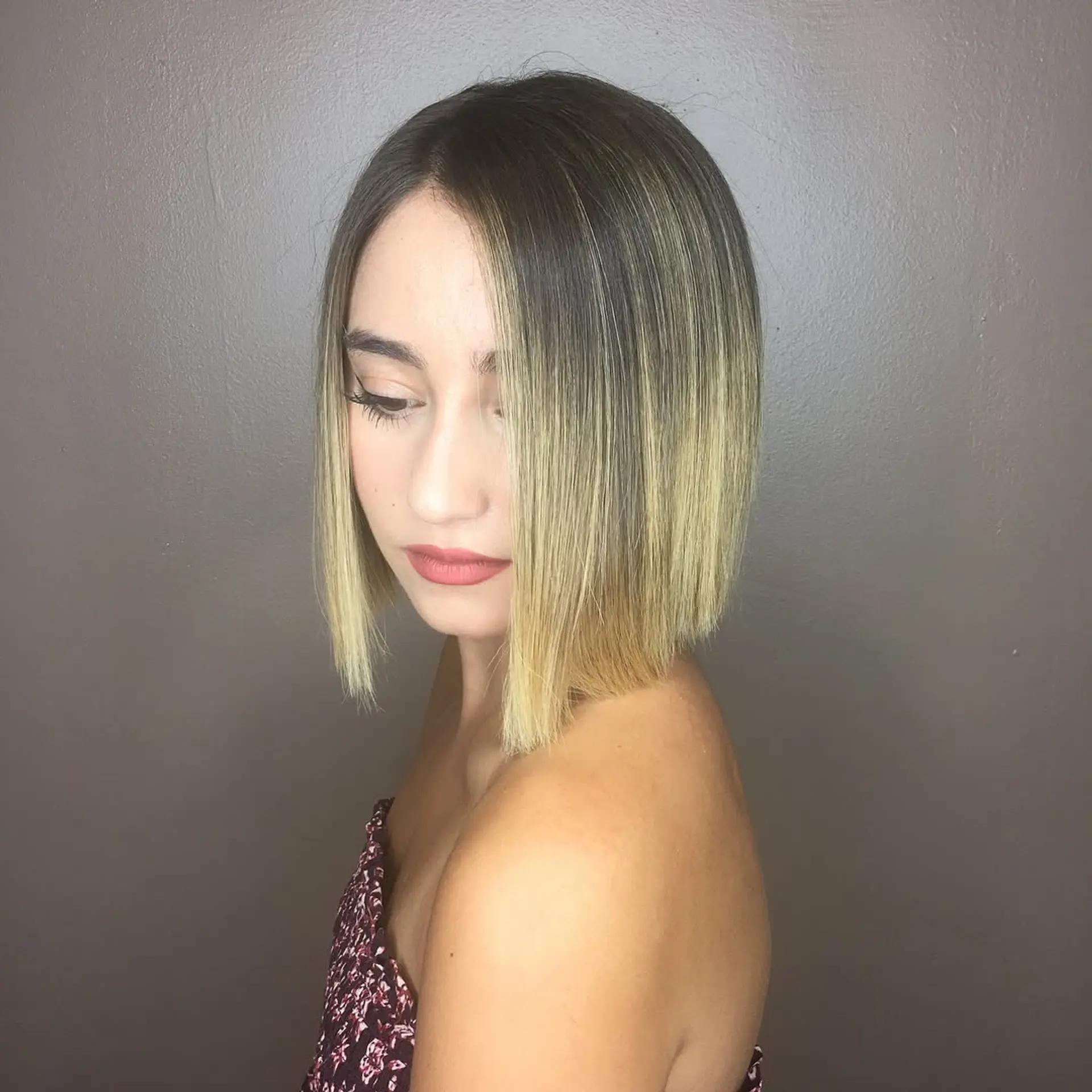 A sleek, straight chin-length blunt bob featuring a dark natural base transitioning into blonde balayage ends. 1