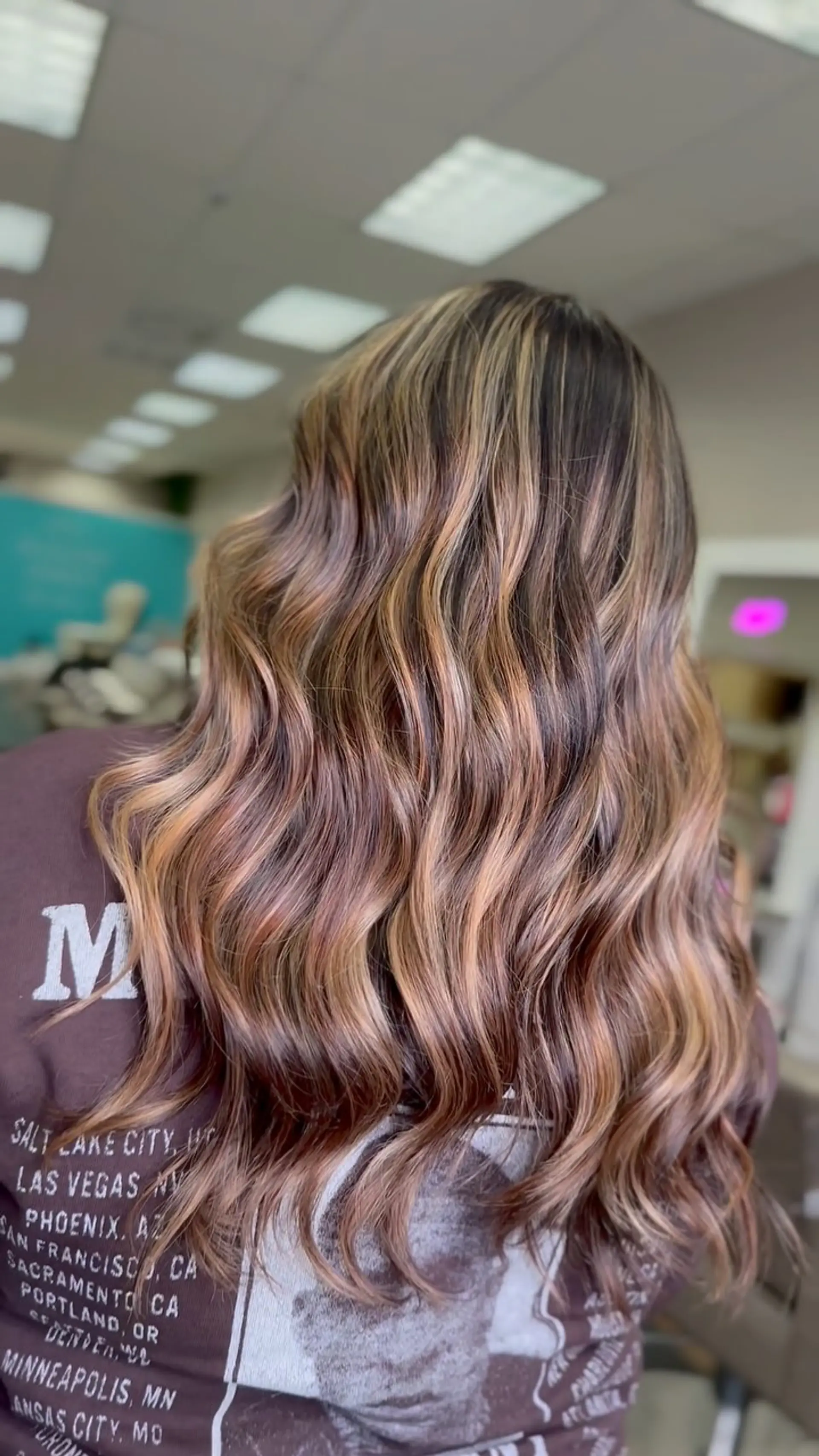 Long wavy hair with a blended caramel balayage over a deep brunette base. 1