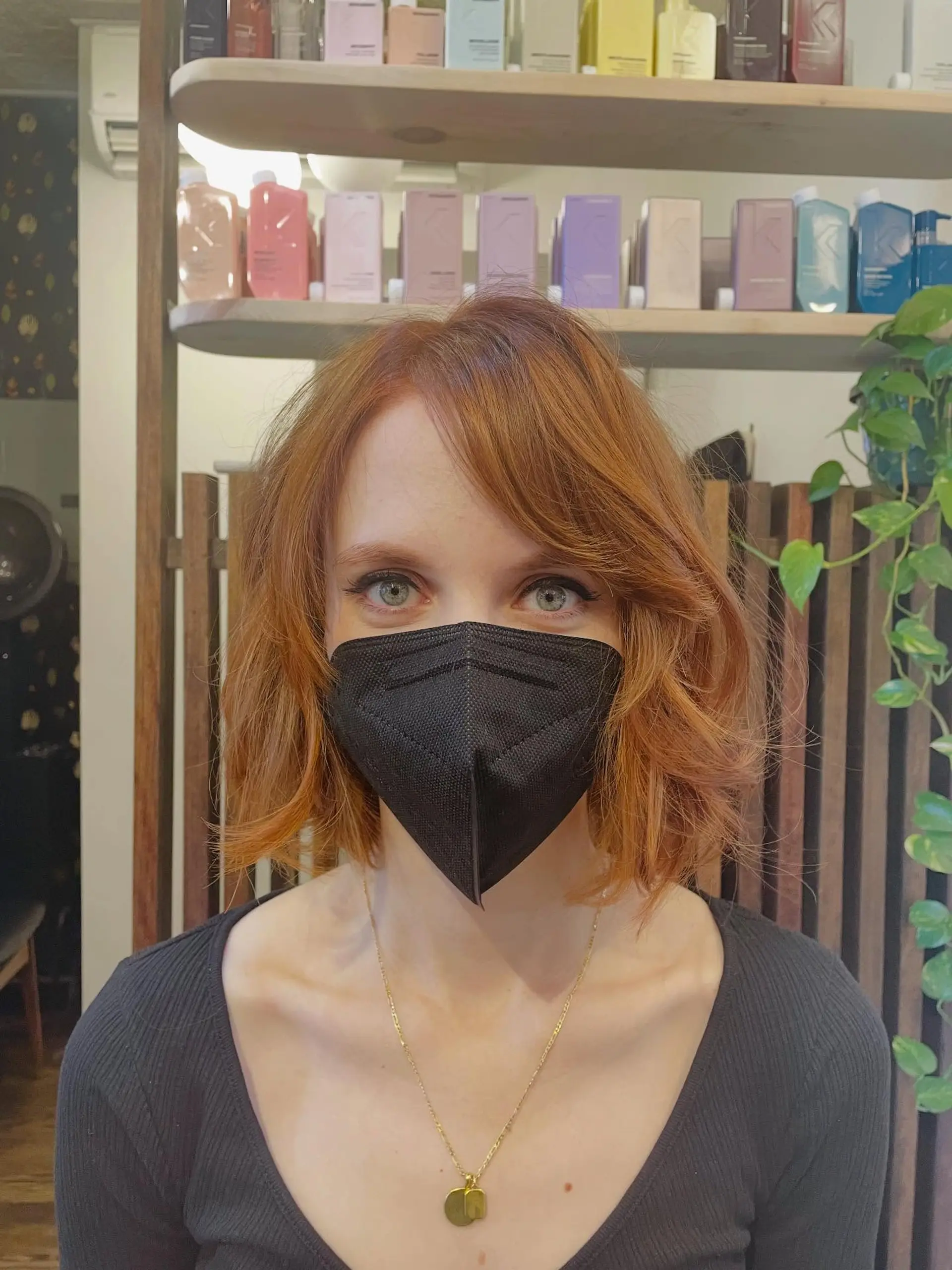 A layered, neck-length bob styled with subtle texture and soft side-swept bangs in a warm sunset copper tone. Current Cut My Hair service: $215 for haircut and included finish only; displayed color is not included. 1