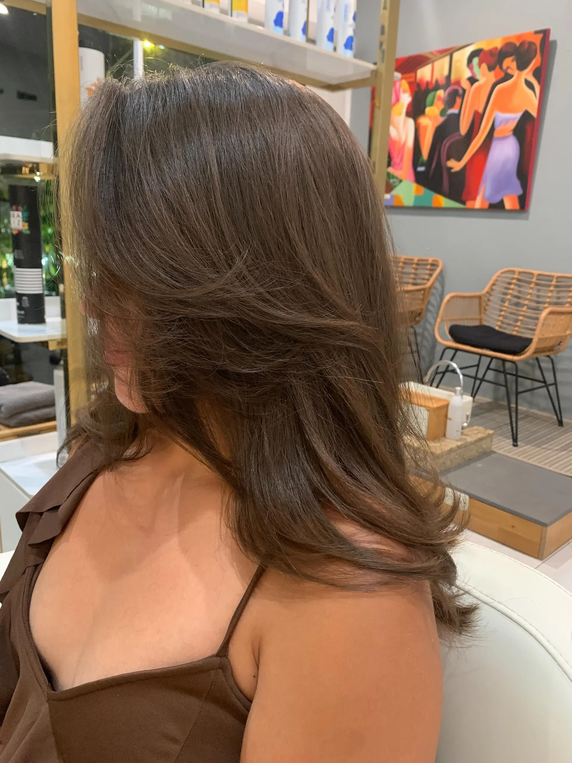 Polished brown hair with soft face-framing layers styled into a voluminous, smooth blowout. 1