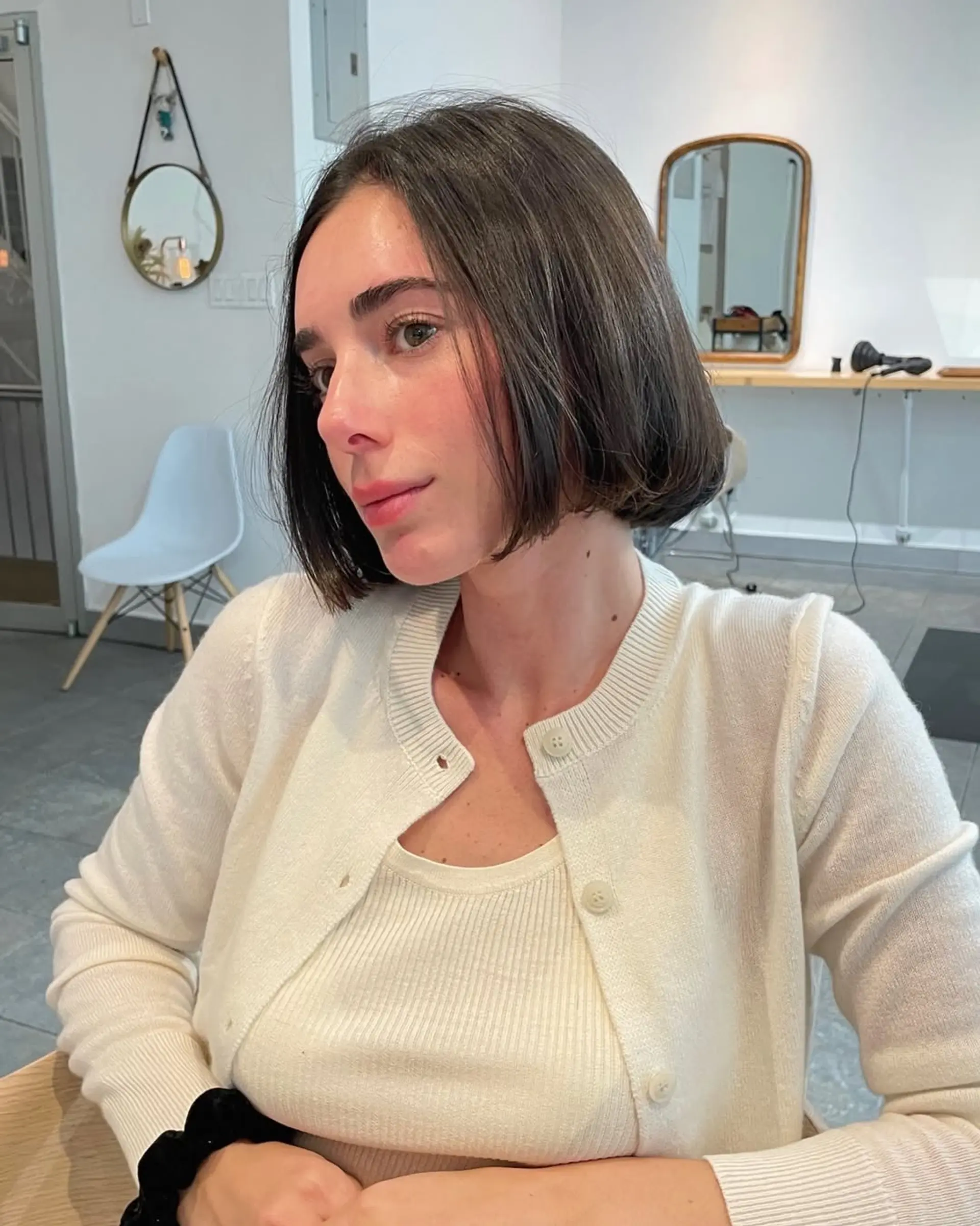 A short, sleek blunt bob cut straight at the chin with minimal layering. 3