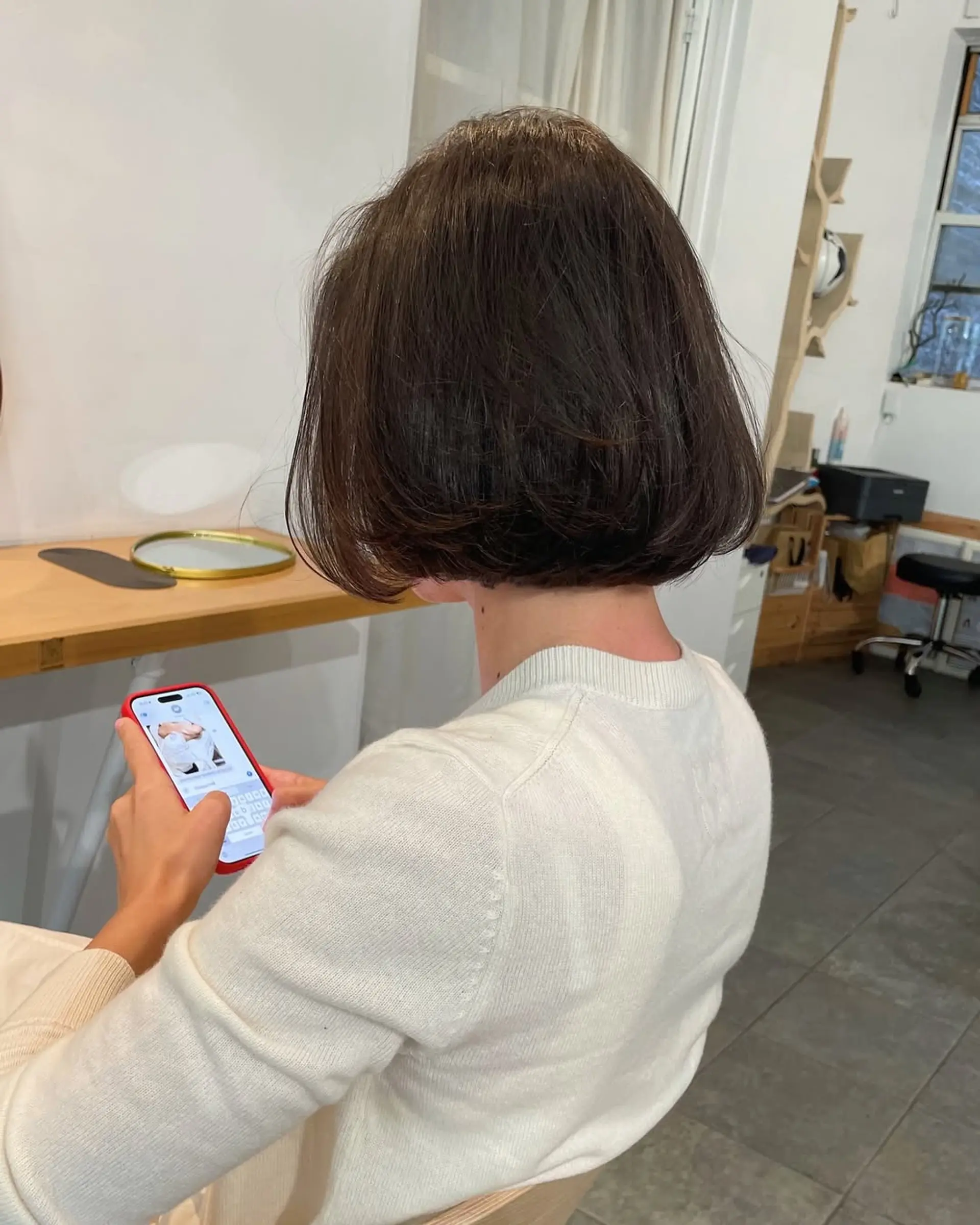 A short, sleek blunt bob cut straight at the chin with minimal layering. 4