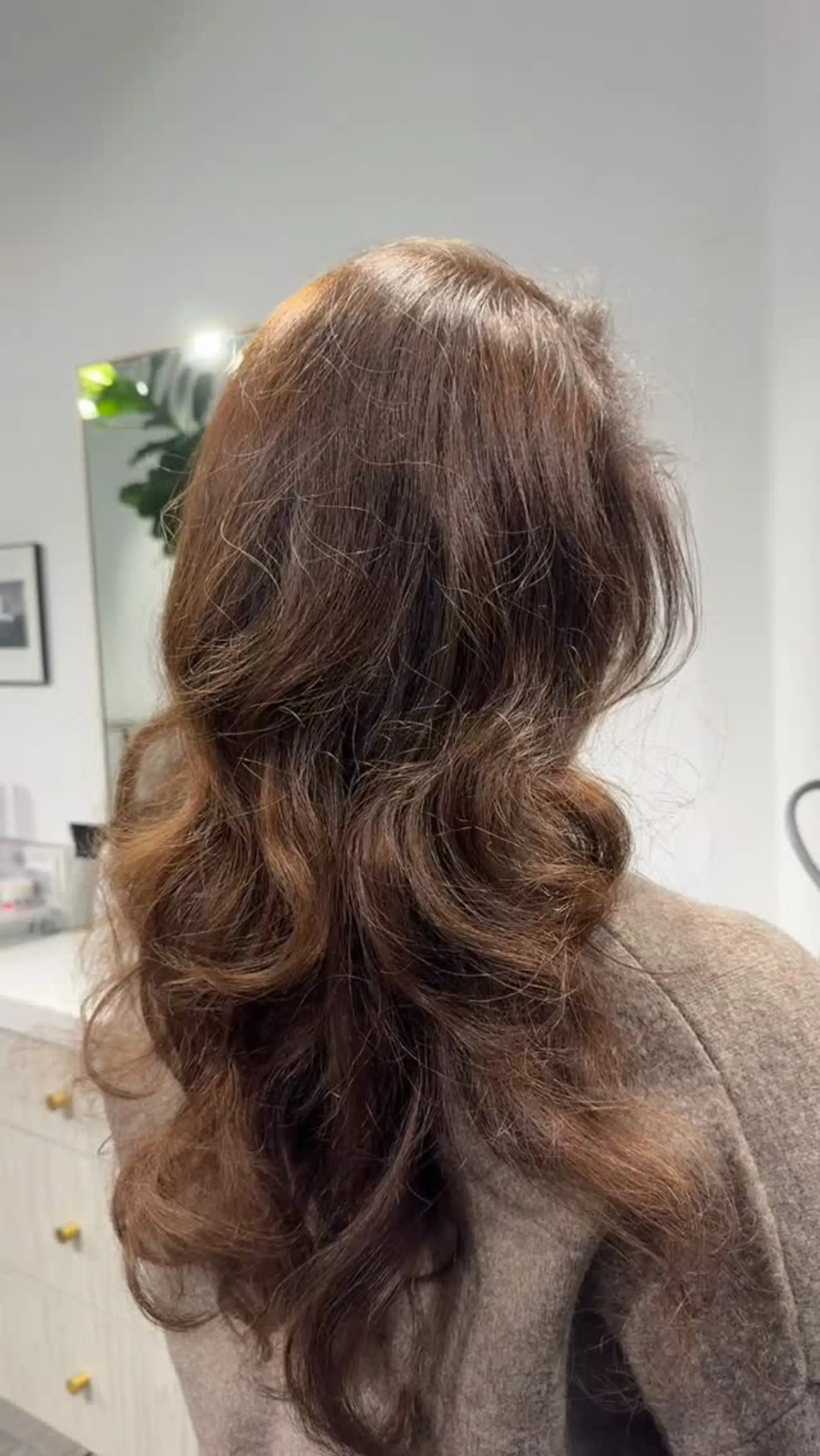 Long warm chestnut brown hair featuring flowing layers and soft, voluminous blowout waves. 1