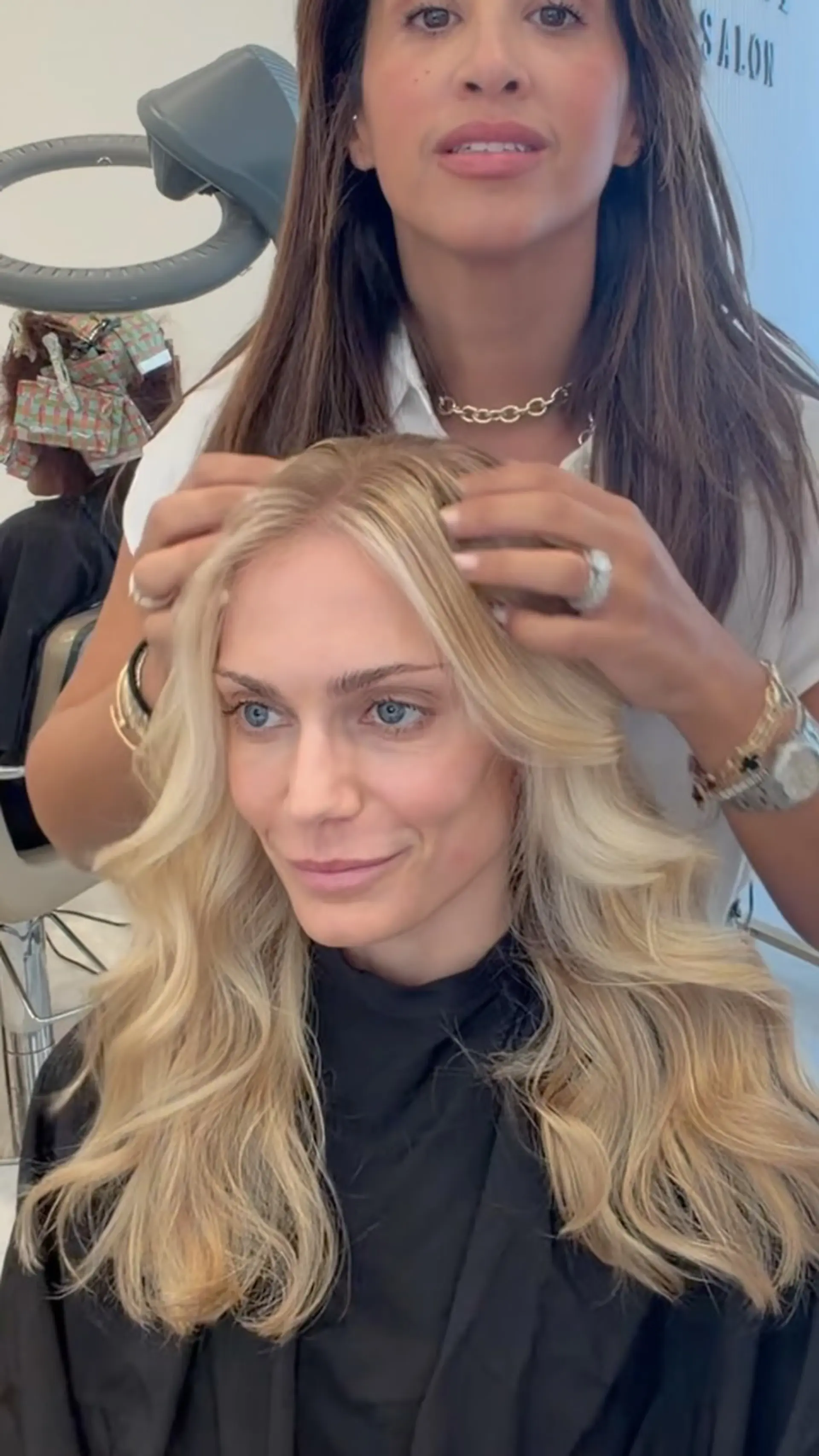 Long bright blonde hair styled in a voluminous blowout with soft, bouncy waves and face-framing layers. 1