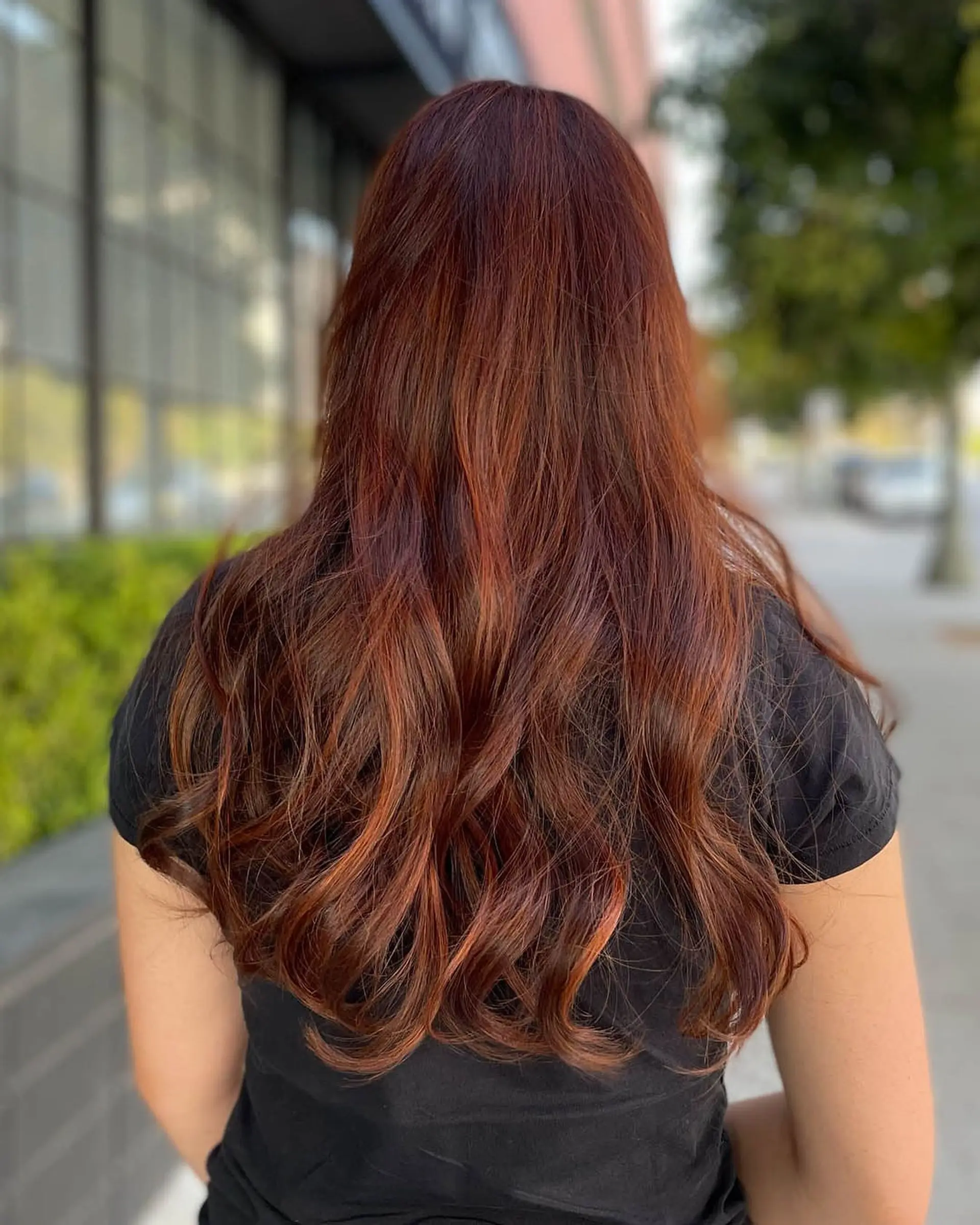 Vibrant copper and auburn balayage across long, layered locks finished with loose, cascading waves. 1