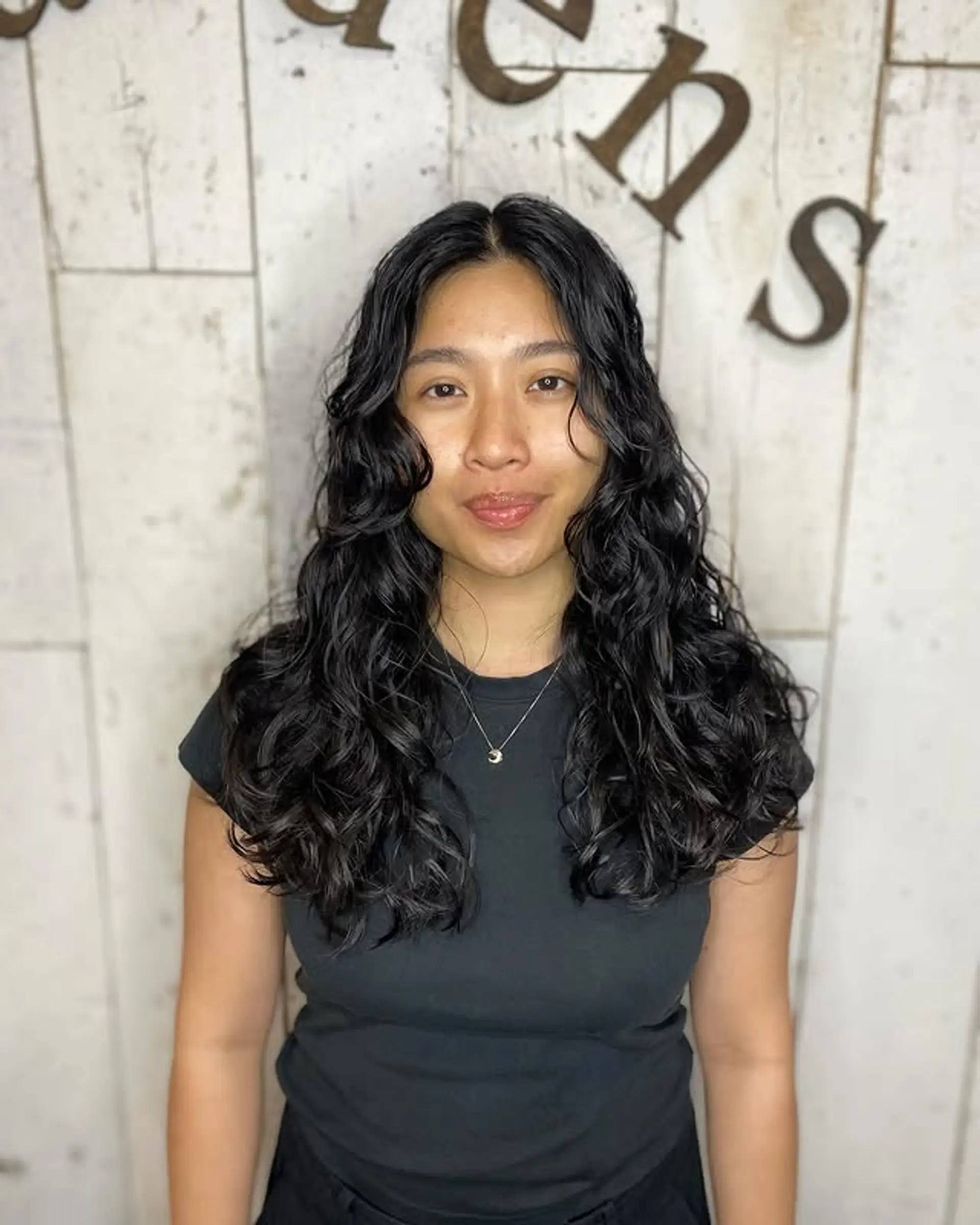 Long, wavy hairstyle with subtle face-framing layers. 1