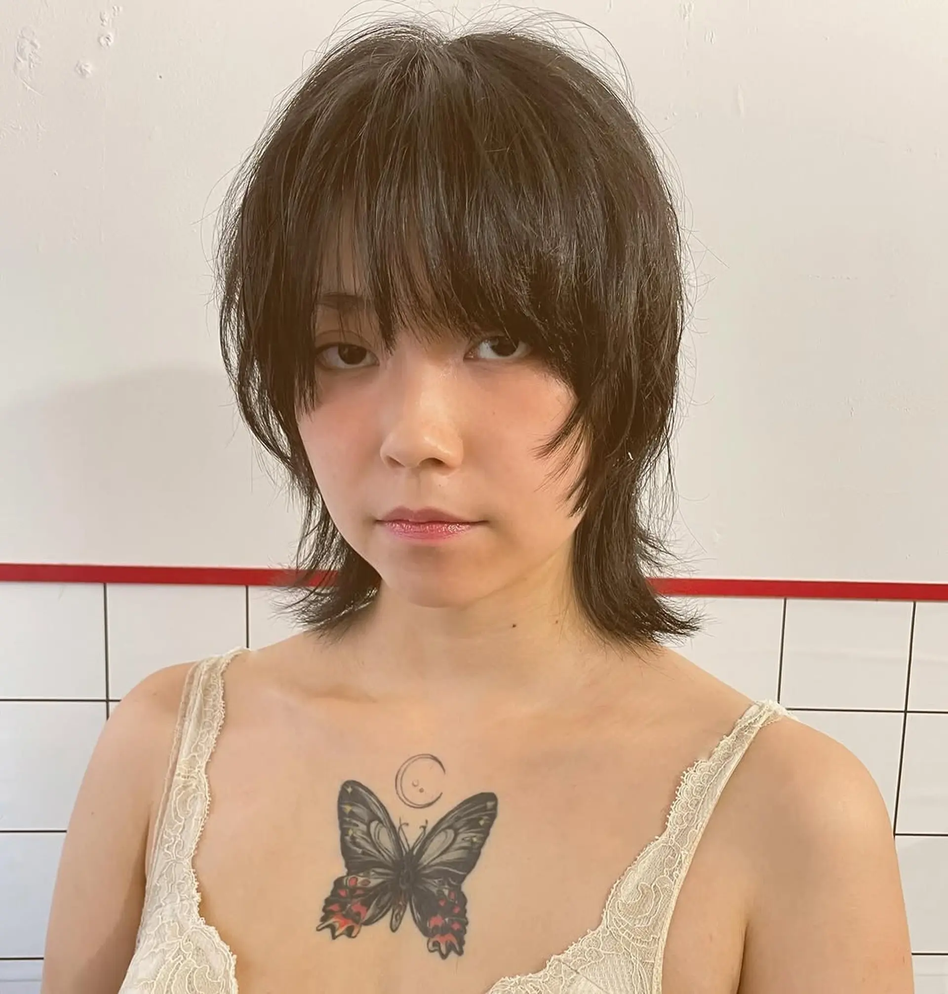 A textured shag haircut with face-framing bangs and layered, choppy ends that create volume and movement. 1