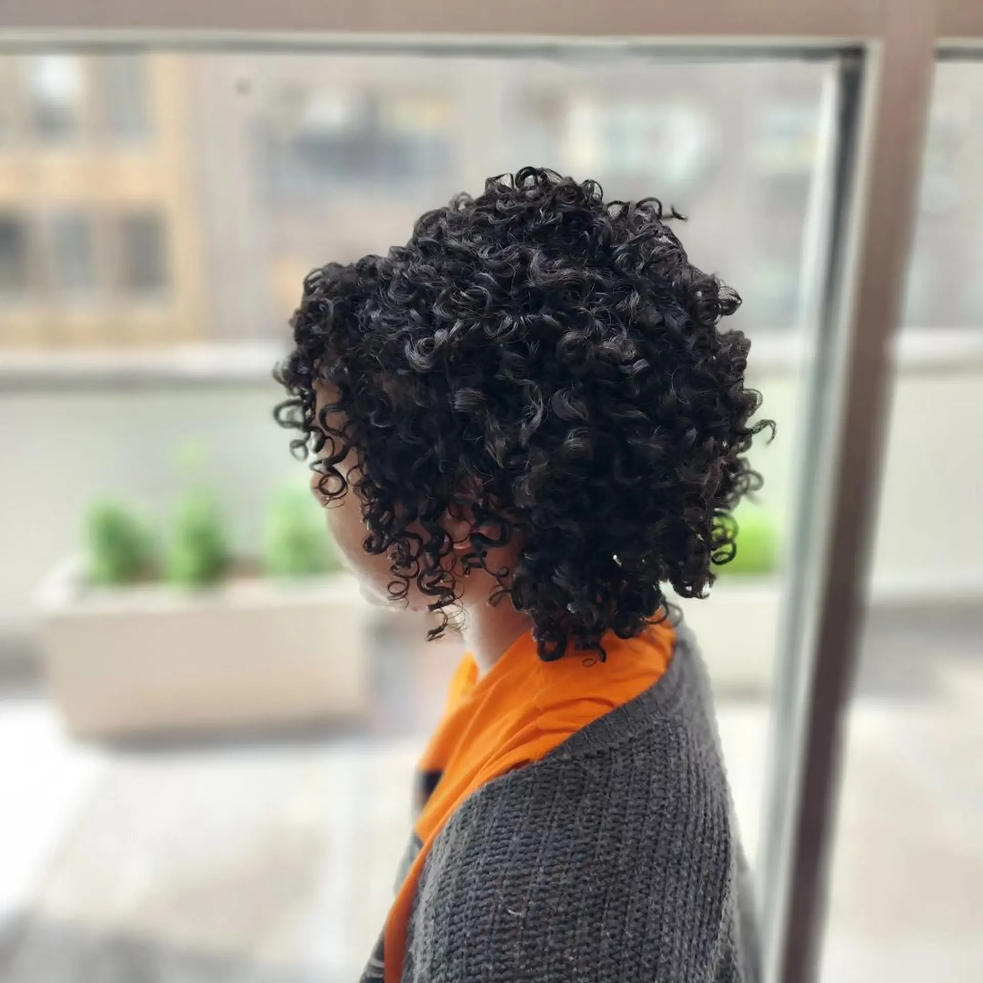 Medium-length, black, curly hair with defined, voluminous curls in a rounded shape, layered for added depth and bounce. 1