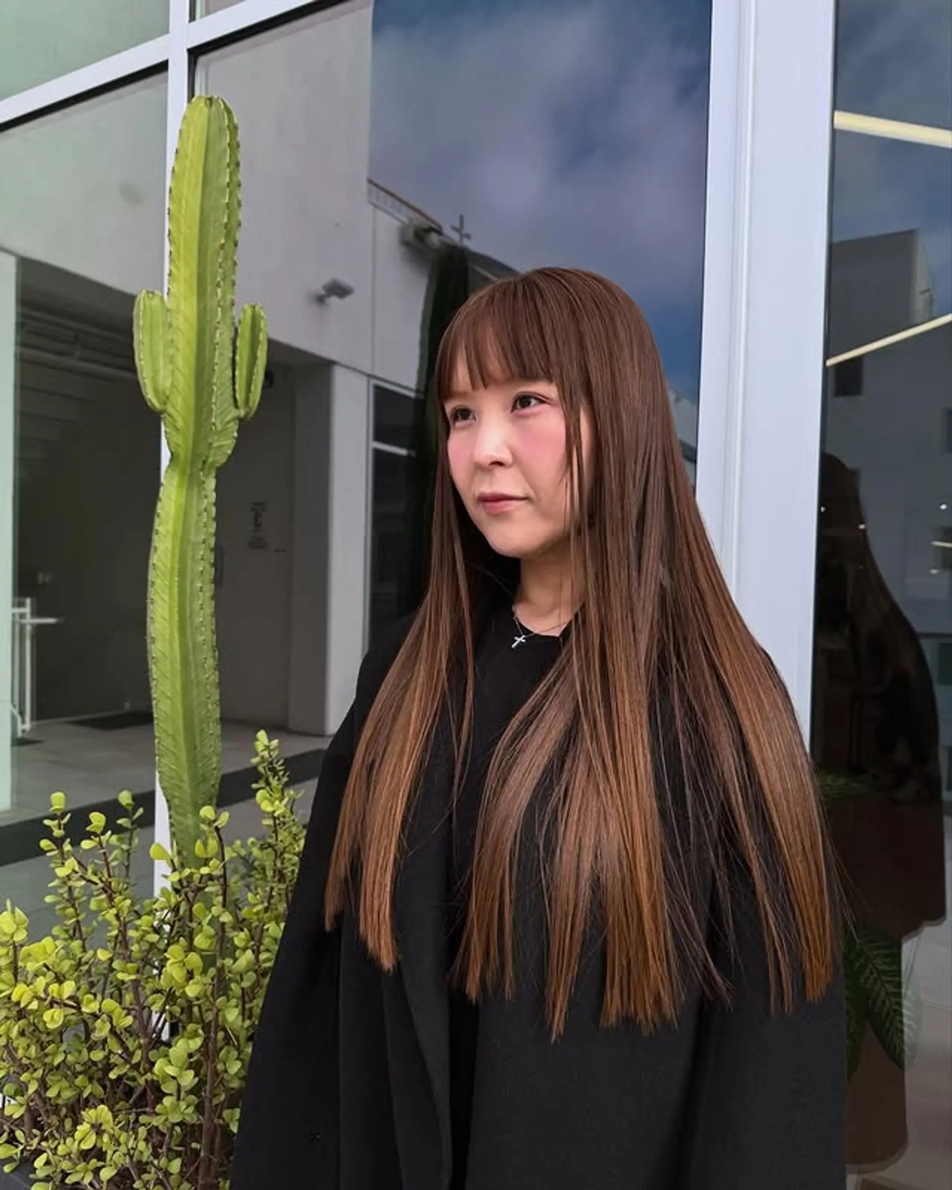 A sleek, straight long hairstyle with a full set of bangs. 1