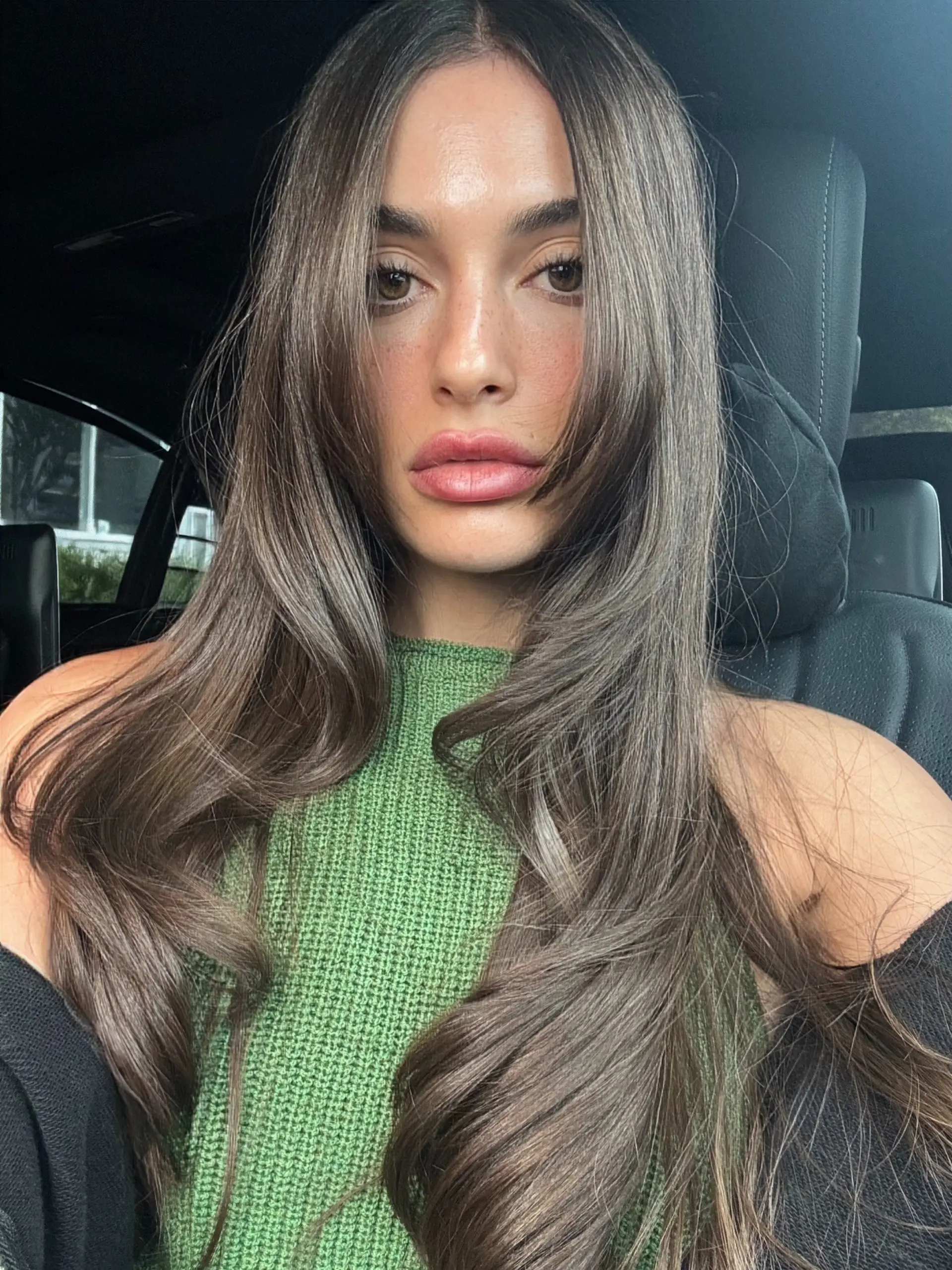 Long ash brunette hair styled with voluminous cascading layers and face-framing fringe. 1