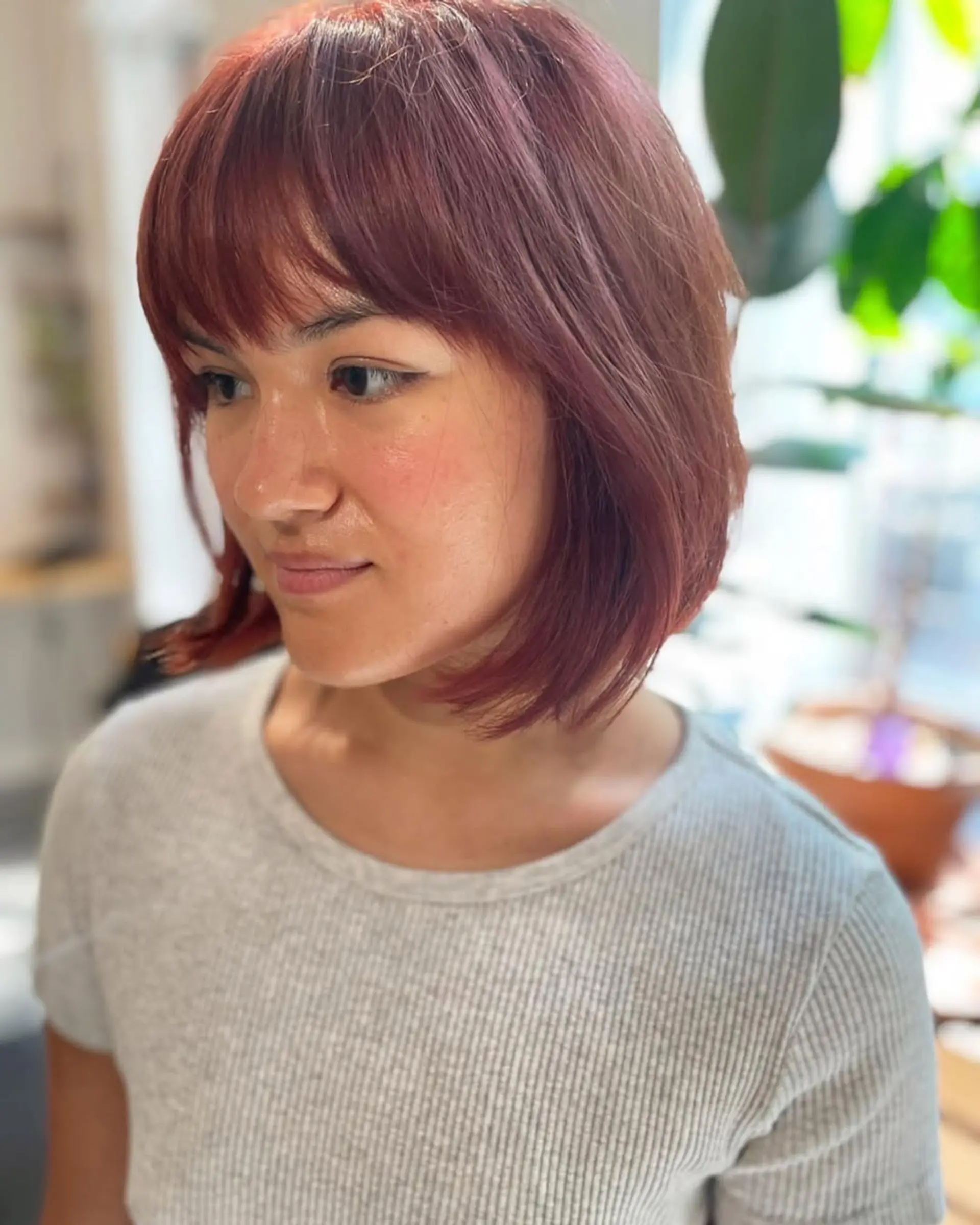 A shaggy, layered bob with face-framing bangs and a textured finish. 1