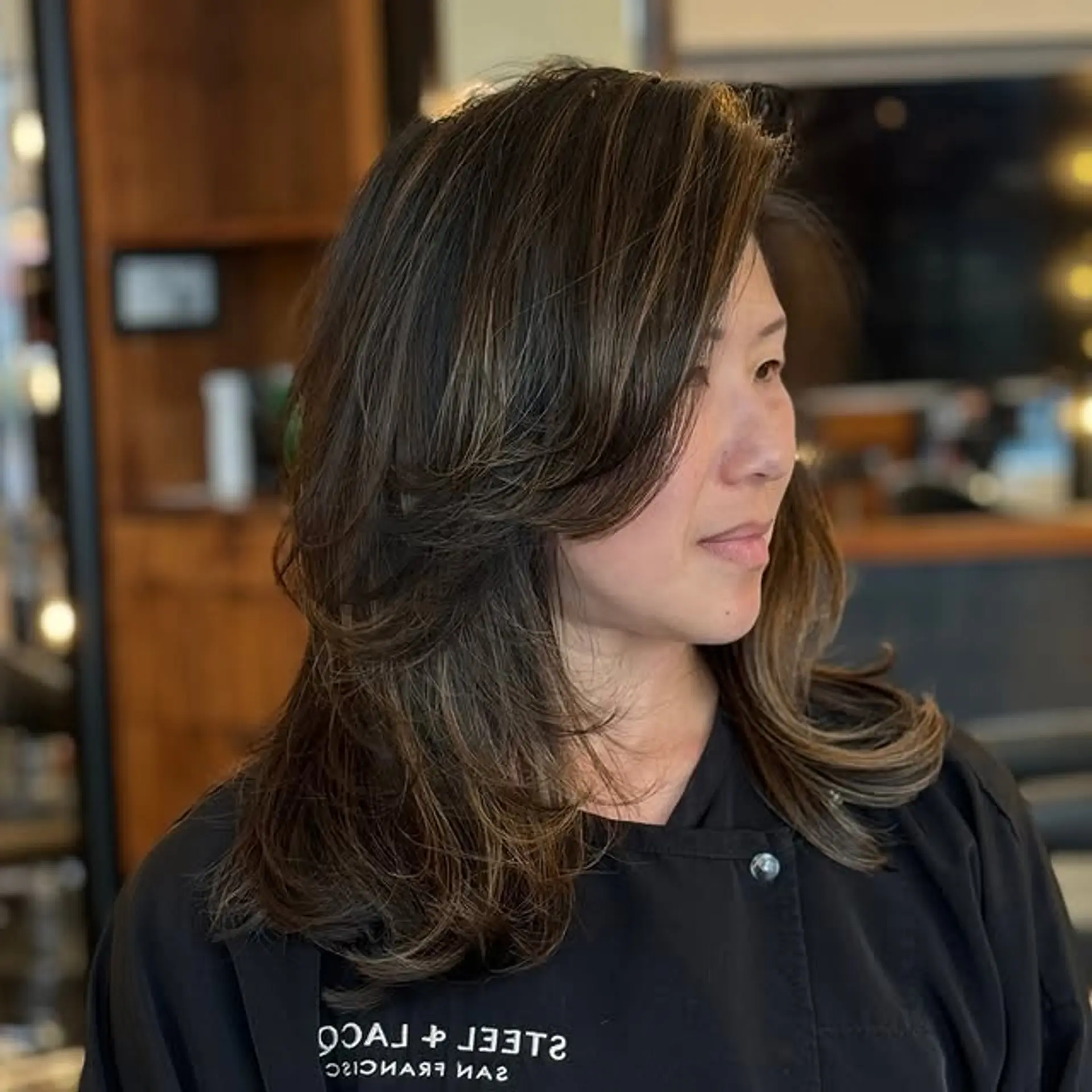 A long layered haircut with face-framing layers and subtle balayage highlights. 1