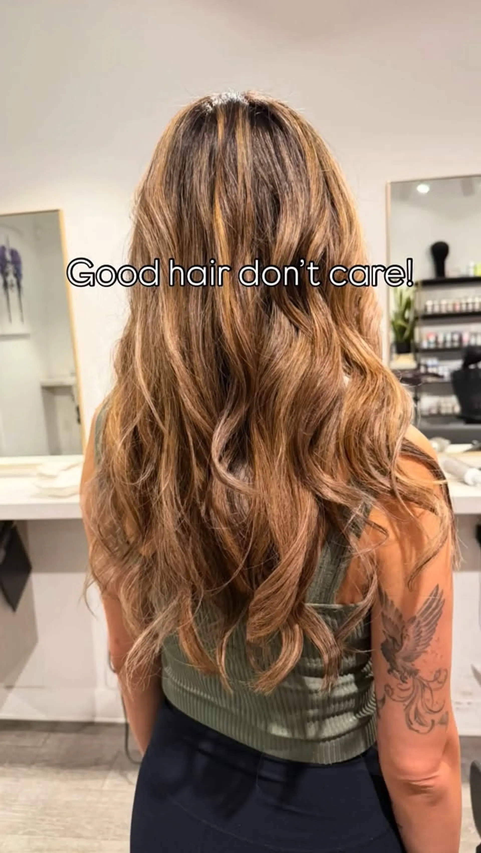 Long layered hair styled in soft, dimensional waves featuring a warm caramel lived-in balayage. 1