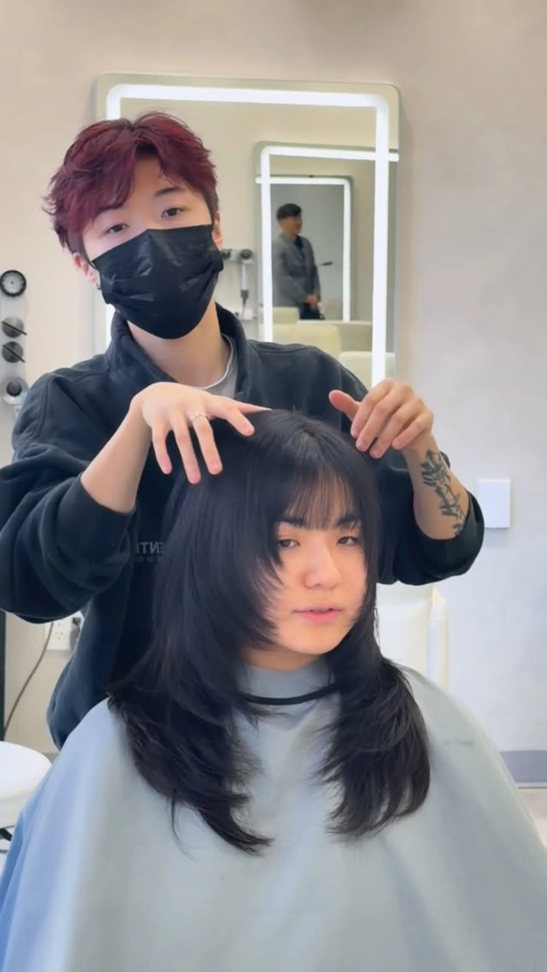 A medium-length textured wolf cut featuring tapered face-framing layers and soft, wispy bangs. 1