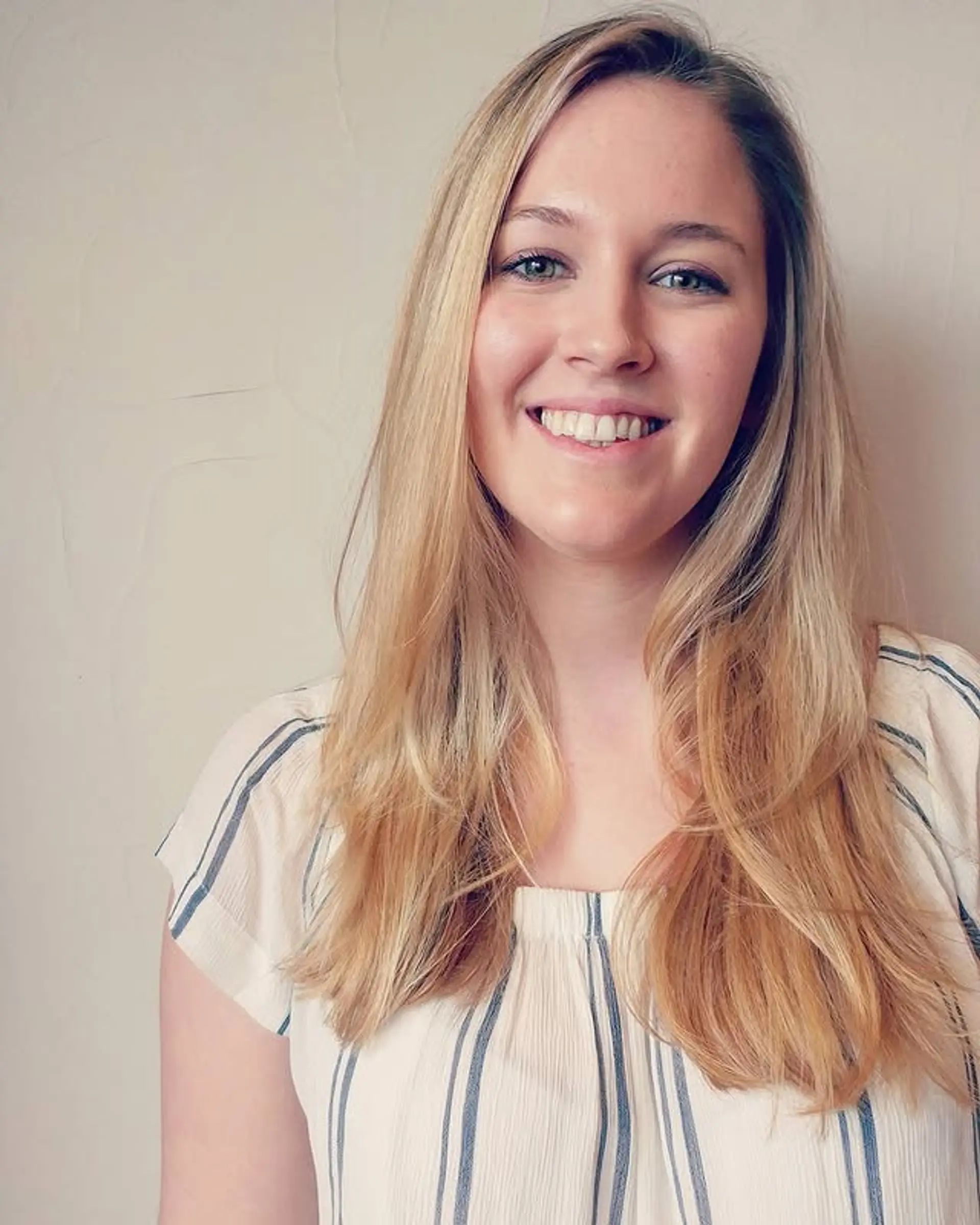 Long layered hairstyle with subtle face-framing layers and a sun-kissed balayage. 1