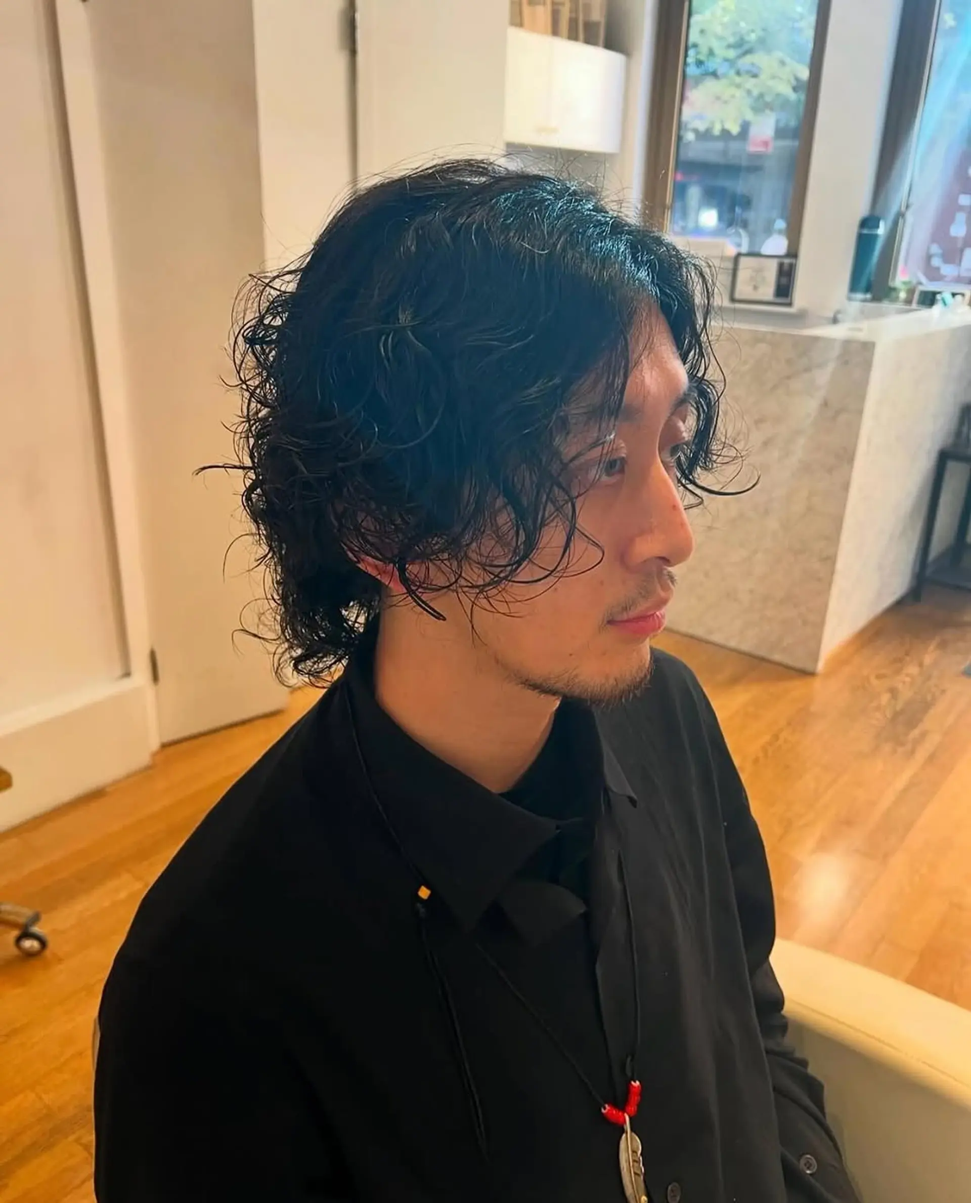 A textured wavy hairstyle achieved with a modern perm. 1