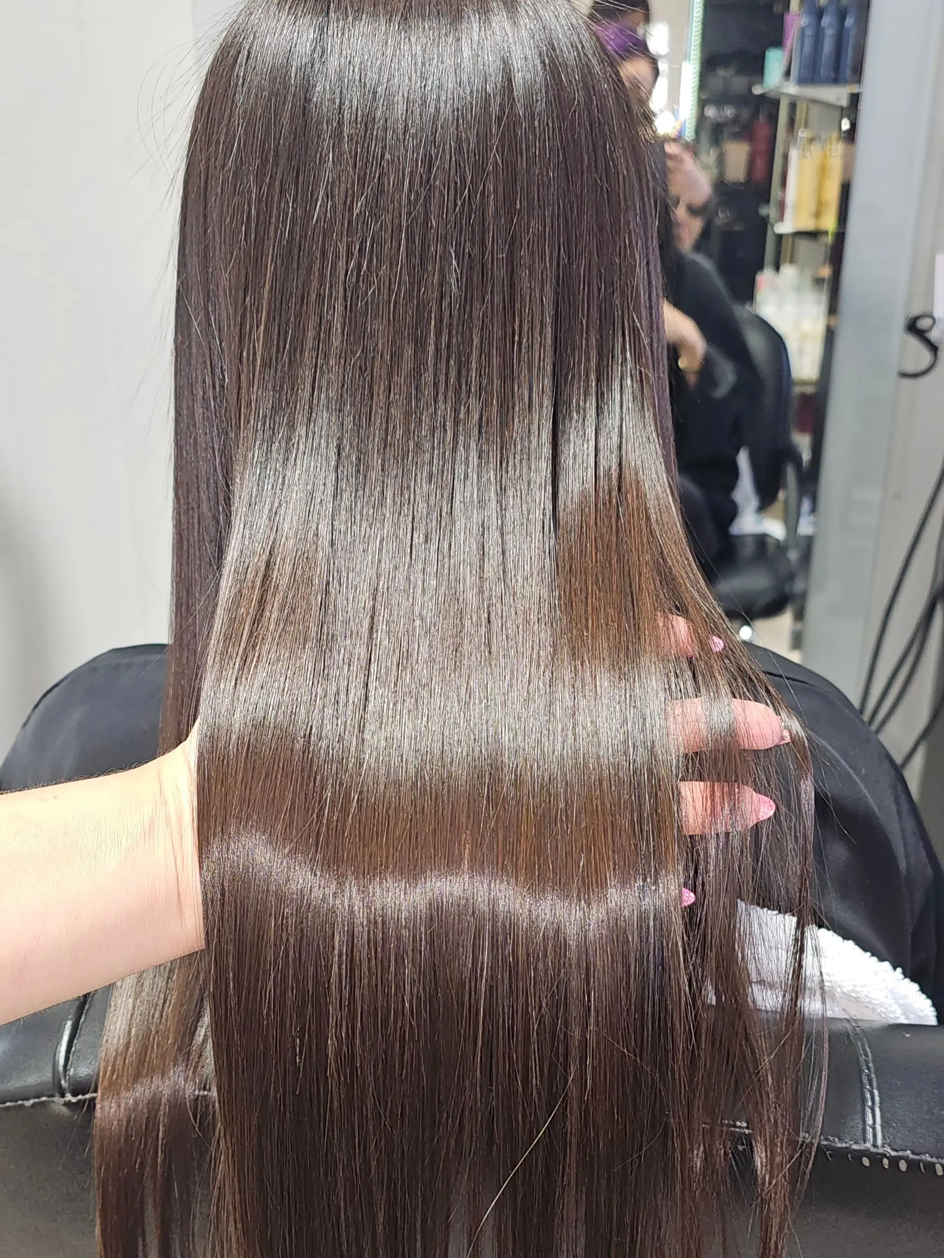 Ultra-sleek, glossy long dark brown hair styled completely straight. 1