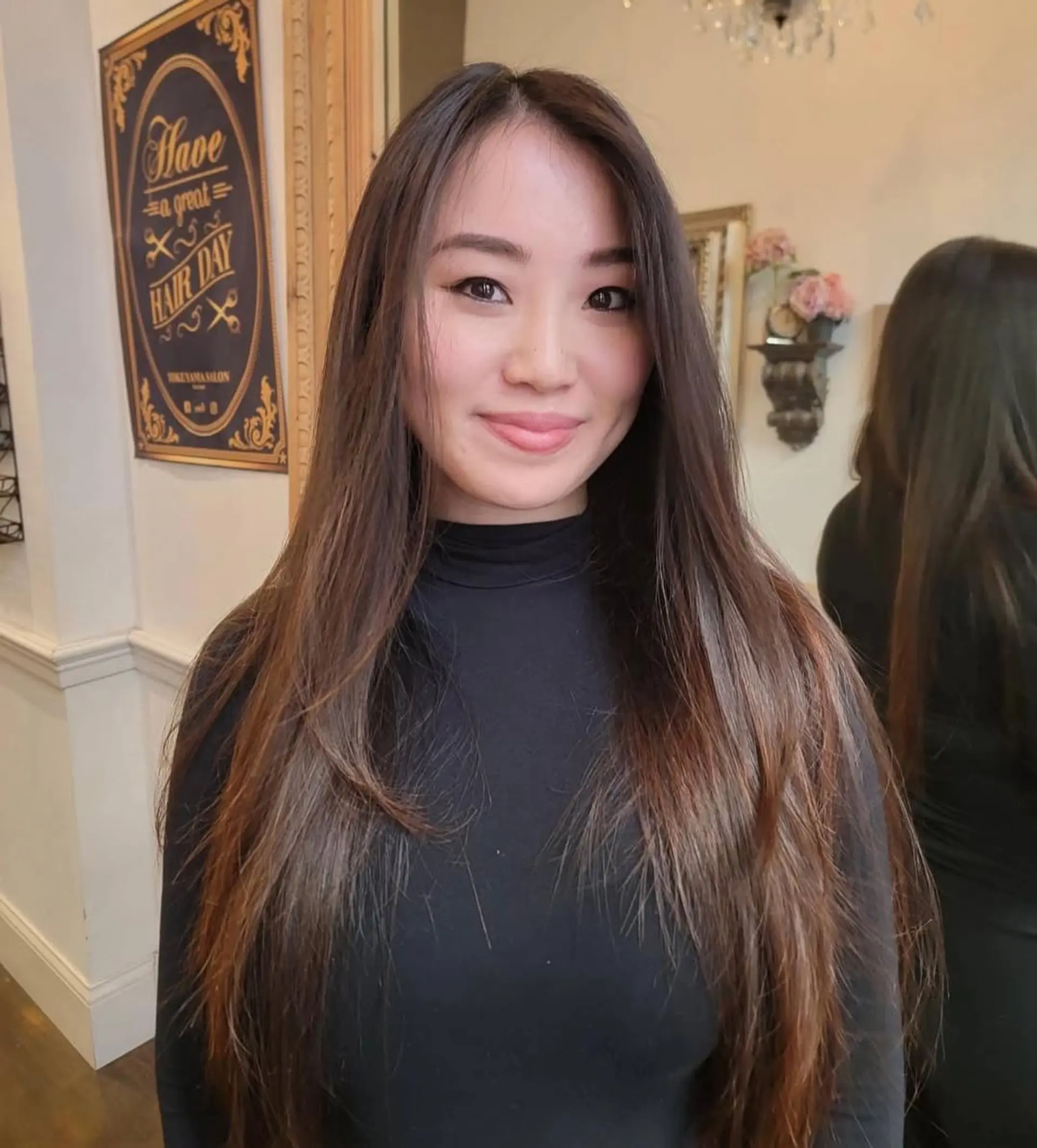 Long, straight, and sleek hairstyle with a center part and minimal layers in dark brown. 1