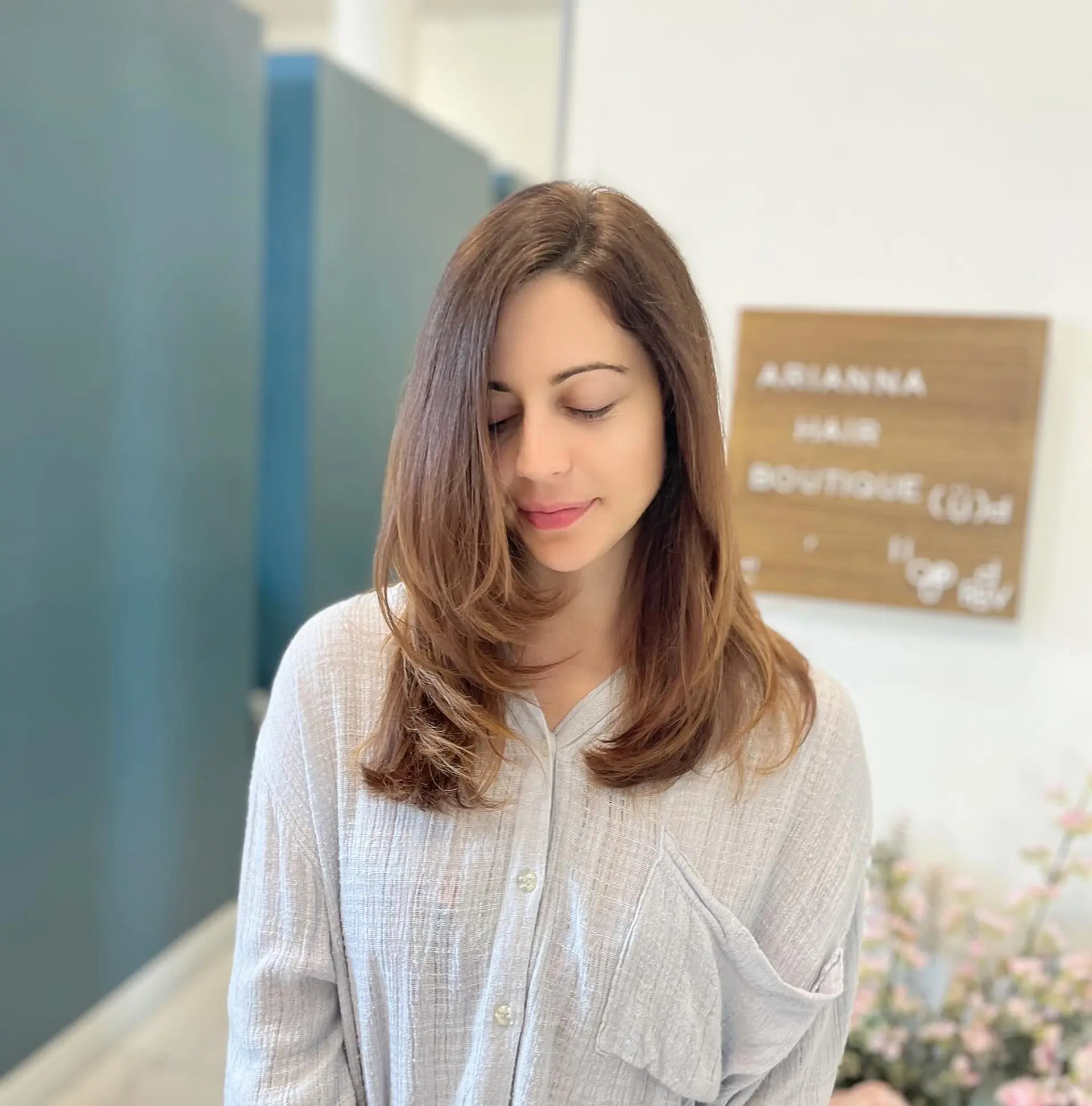 Medium-length haircut with face-framing layers and smooth, inward-curling ends. 1