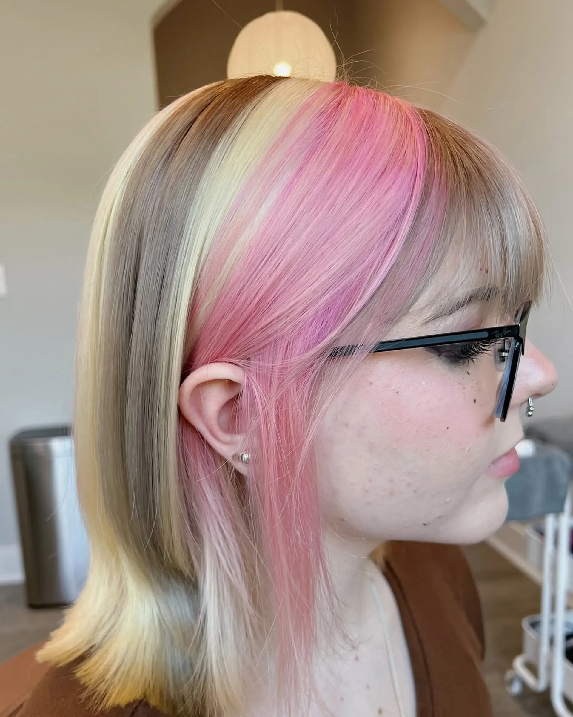 Medium-length straight bob with a bold color block design, featuring prominent sections of ash blonde, bright blonde, and vibrant pastel pink, complemented by natural brown roots and soft, face-framing layers. 1