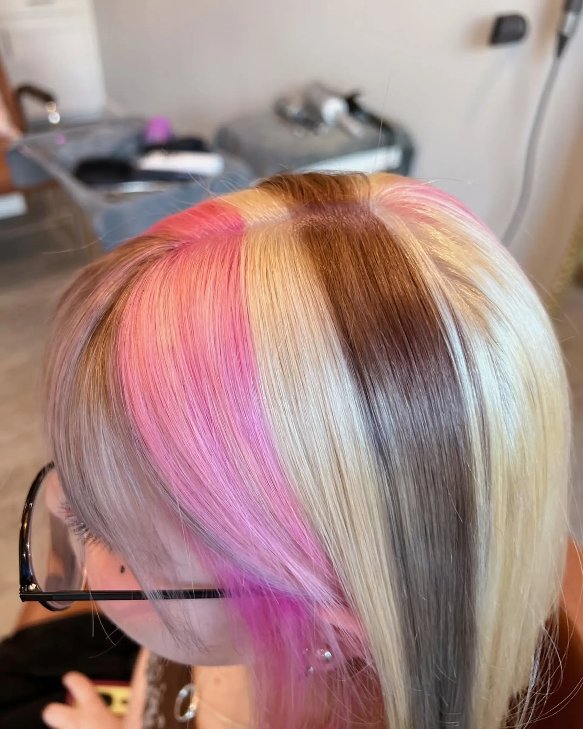 Medium-length straight bob with a bold color block design, featuring prominent sections of ash blonde, bright blonde, and vibrant pastel pink, complemented by natural brown roots and soft, face-framing layers. 4