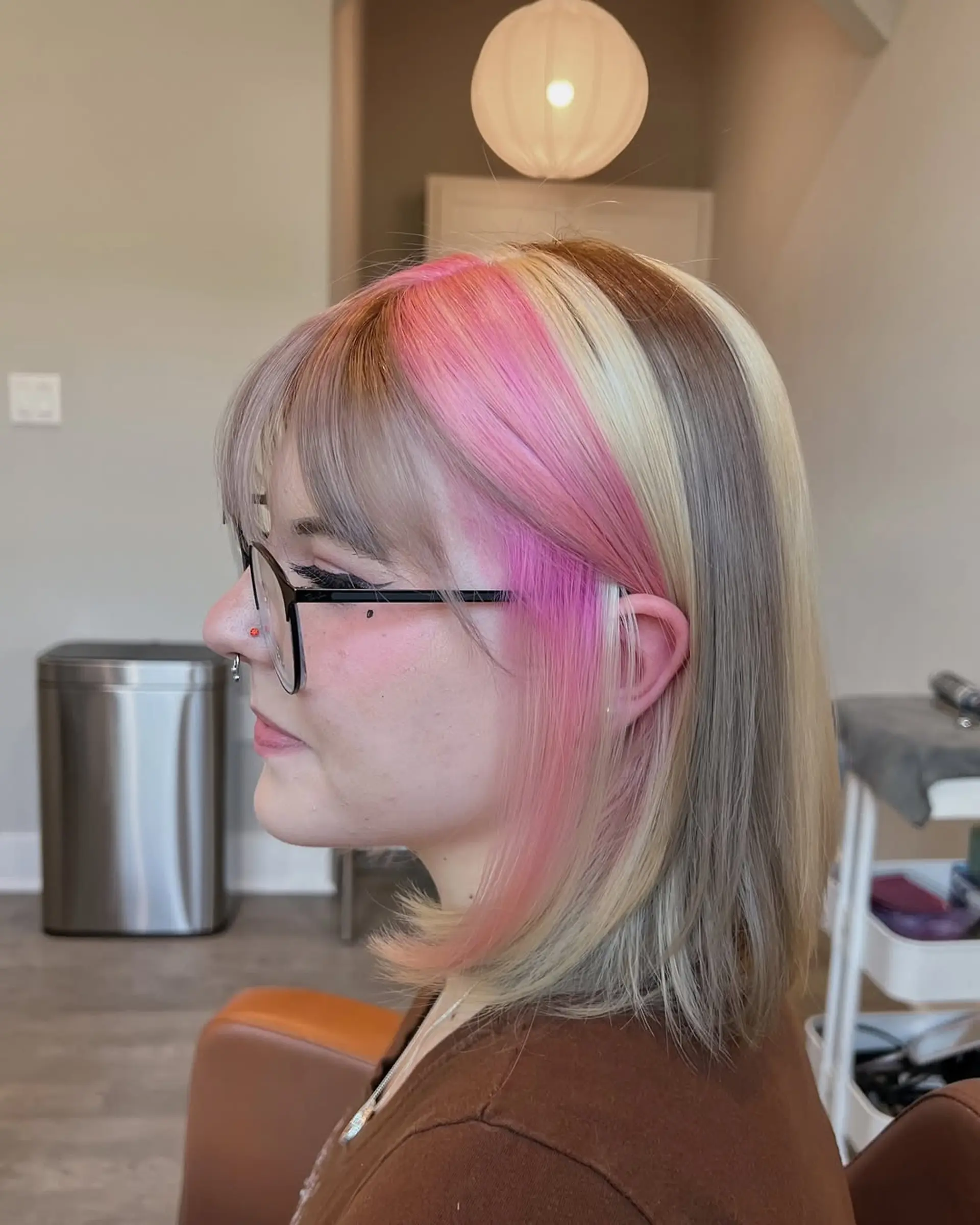 Medium-length straight bob with a bold color block design, featuring prominent sections of ash blonde, bright blonde, and vibrant pastel pink, complemented by natural brown roots and soft, face-framing layers. 2