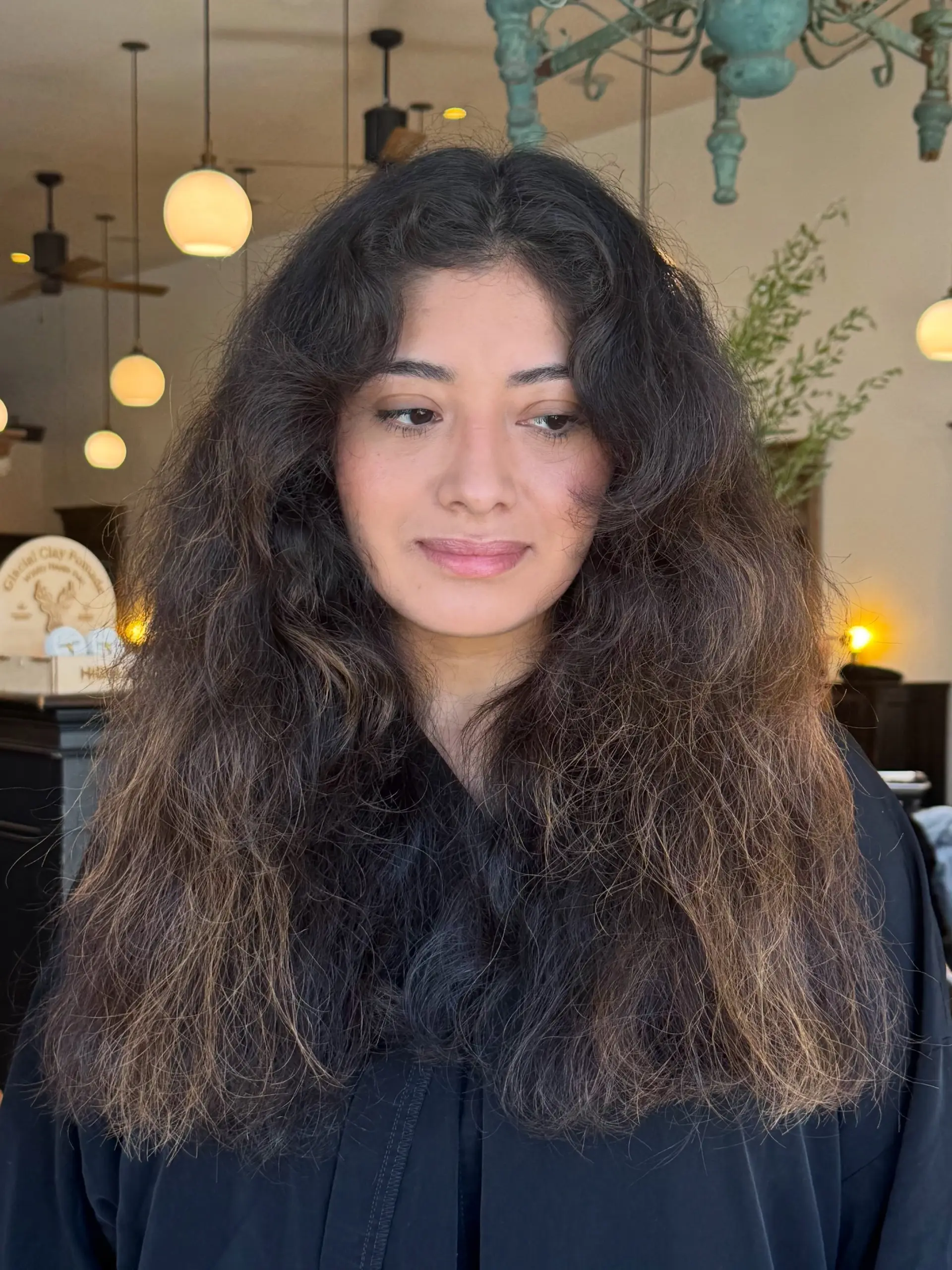 Long, voluminous dark brown wavy hair featuring face-framing curtain bangs and full, textured layers. 1