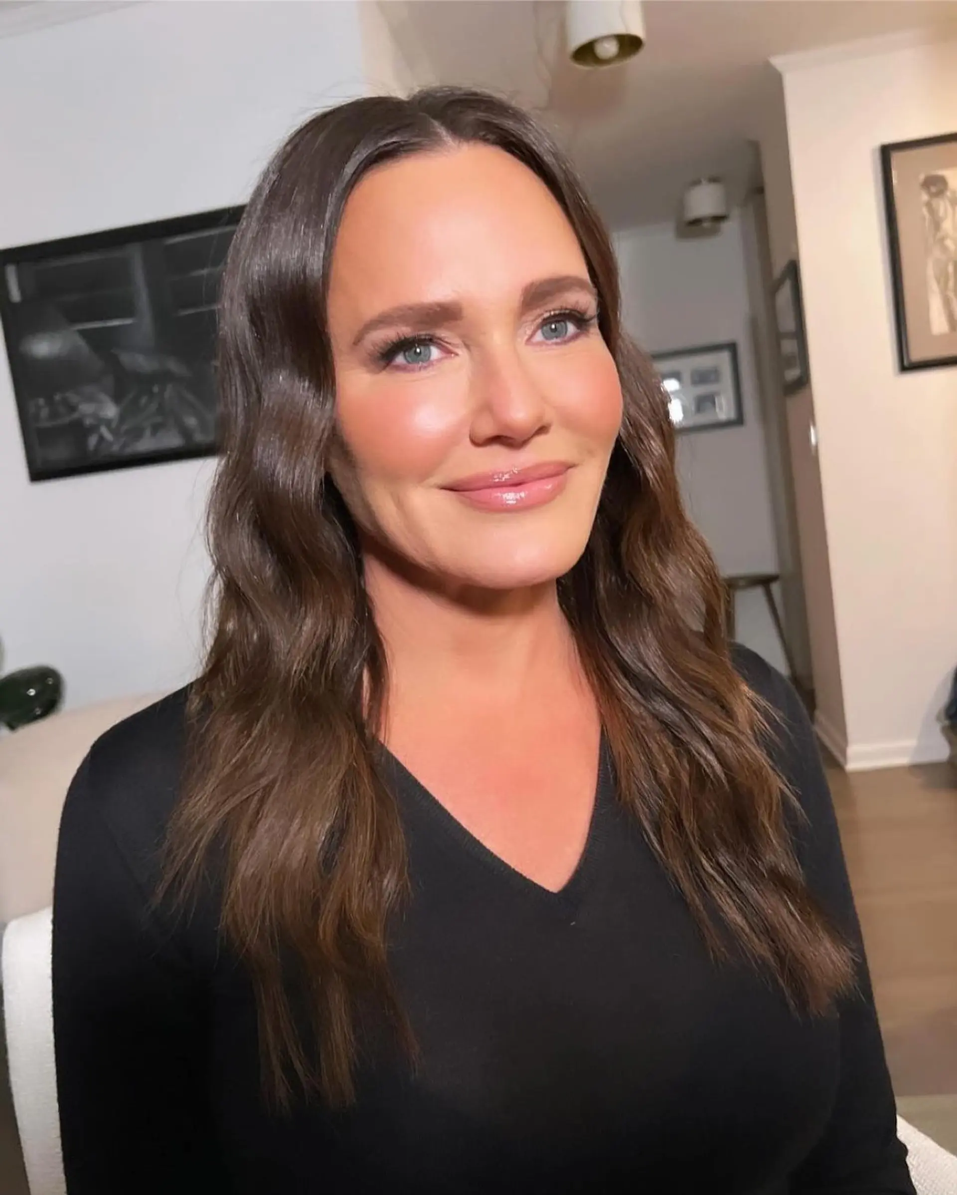 Long brunette hair styled in glossy, uniform S-waves parted down the middle. 1